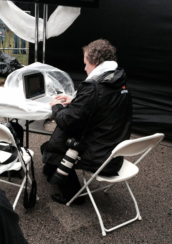 A reporter files his story on a laptop draped with plastic sheeting on the bitterly cold and damp 50th anniversary ceremony to remember President John F. Kennedy in Dallas.

 



