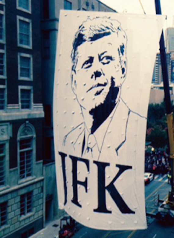 A commemorative banner is moved through the streets of downtown Dallas to its position in the 50th anniversary ceremony. (Courtesy City of Dallas)


