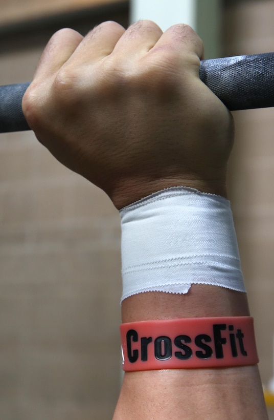 Sgt. Aaron Gardner, a training clerk with Headquarters and Headquarters Squadron (H&HS), shows off his CrossFit bracelet during one of his daily training sessions aboard Marine Corps Air Station Miramar, Calif., Dec. 6. Gardner trains up to three times a day in preparation for the OC (Orange County) Throwdown, Jan. 11 to 12, and has pursued the opportunity to perform in this competition since 2011, when he first heard about it on deployment.