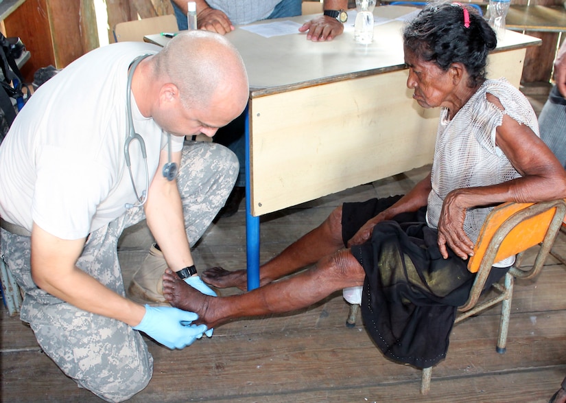 U.S. Army Captain Andrew Foss provides medical care to a Honduran woman during a Medical Readiness Training Exercise (MEDRETE) in the Department of Gracias a Dios, Honduras, Dec. 3, 2013.  Joint Task Force-Bravo's Medical Element (MEDEL) provided medical care to more than 1,200 Honduran citizens during the two day MEDRETE operation.  (Photo by U.S. Army Sgt. Courtney Kreft)