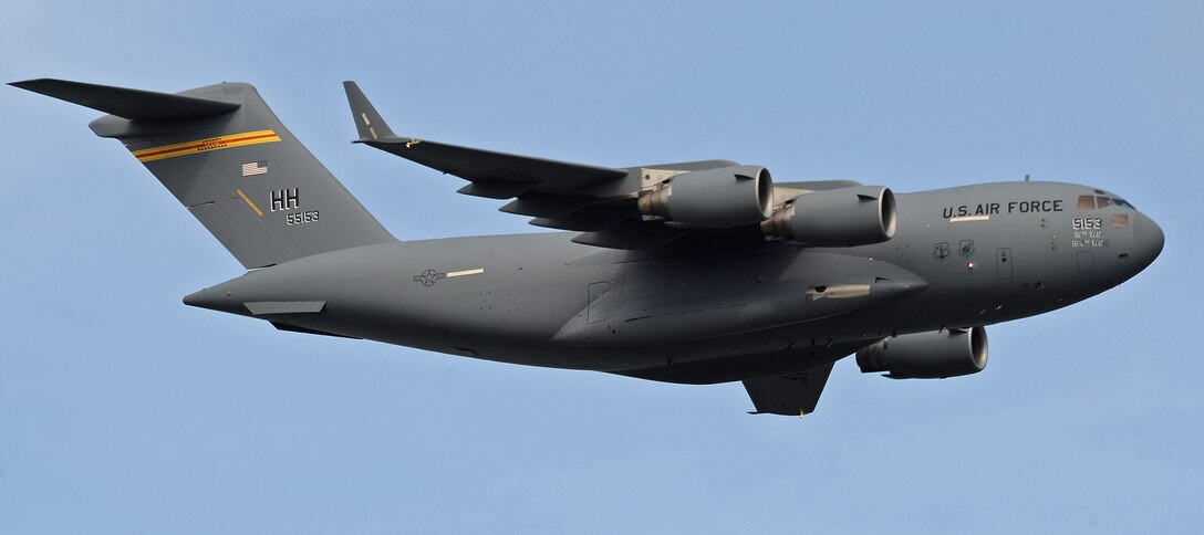 A C-17 Globemaster III flies by an assembled crowd of spectators during the fourth biennial Brunei Darussalam International Defense Exhibition at the BRIDEX Exhibition Center in Bandar Seri Begawan, Brunei, Dec. 5, 2013. BRIDEX 13 is a five-day event compromised of social events, displays and demonstrations. BRIDEX 13 is an opportunity for networking and sharing technology with regional partners and allies which builds strong multilateral relationships, increases cooperation and enhances preparedness for disasters and other contingency operations. (U.S. Air Force photo/Master Sgt. Jerome S. Tayborn)