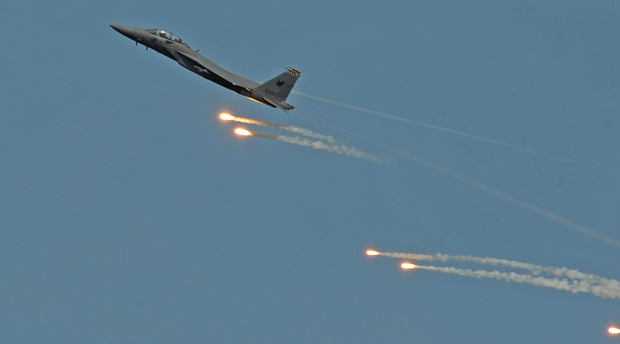 A Singapore Air Force F-15E Strike Eagle deploys flares during the fourth biennial Brunei Darussalam International Defense Exhibition at the BRIDEX Exhibition Center in Bandar Seri Begawan, Brunei, Dec. 5, 2013. BRIDEX 13 is an opportunity for networking and sharing technology with regional partners and allies which builds strong multilateral relationships, increases cooperation and enhances preparedness for disasters and other contingency operations. (U.S. Air Force photo/Master Sgt. Jerome S. Tayborn)