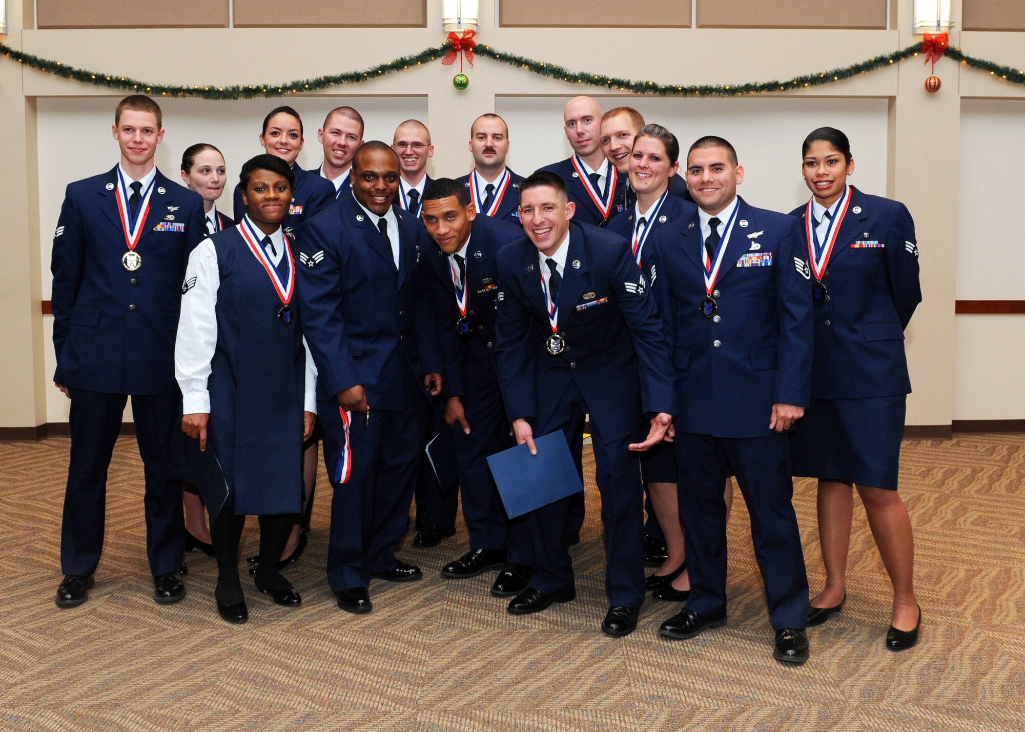 Buckley Airman Leadership School Class 14-A poses after receiving diplomas Dec. 4, 2013, at the Leadership Development Center on Buckley Air Force Base, Colo. ALS is the first step in professional military education and is designed to develop Airmen into effective front-line supervisors. (U.S. Air Force photo by Senior Airman Marcy Copeland/Released)