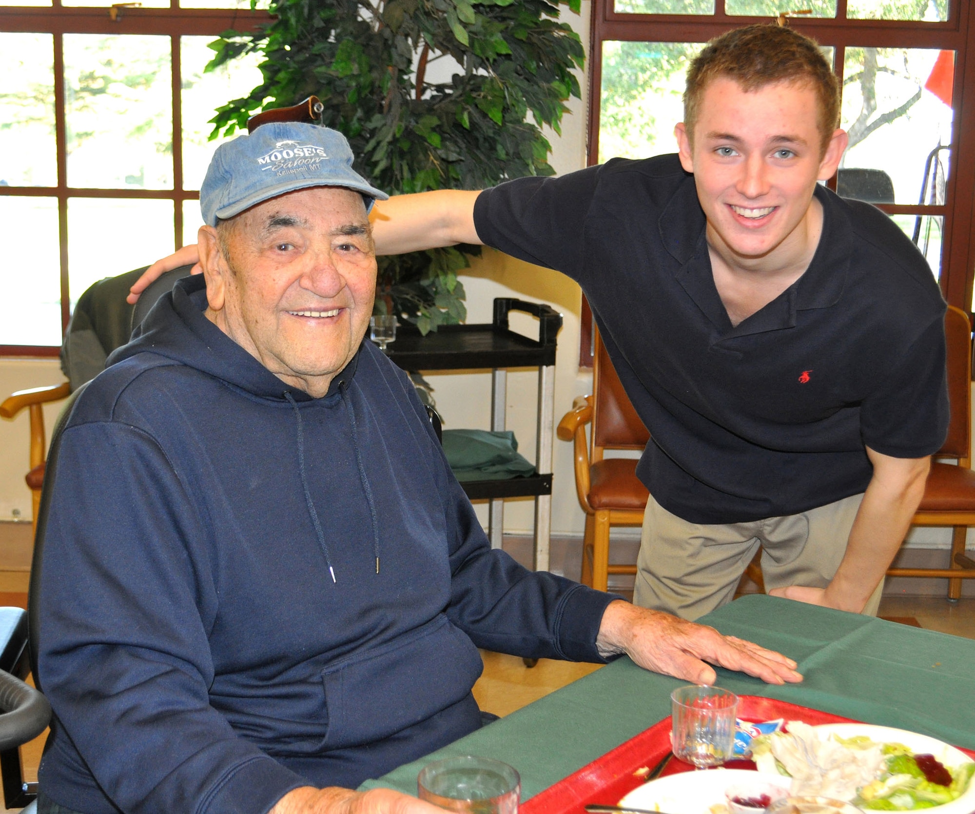 TRAVIS AIR FORCE BASE, Calif. --  Jake Burger, son of Col. Matt Burger, 349th AMW commander, visits with a veteran on Thanksgiving Day, at the California Veterans Home, Yountville. For a number of years, the wing has coordinated the serving and clean up of the holiday meal as a way to give back to our veterans, and visit with them, and their families. Jake is a junior at the University of Iowa. (U.S. Air Force photo/SMSgt. (ret) Ellen Hatfield)