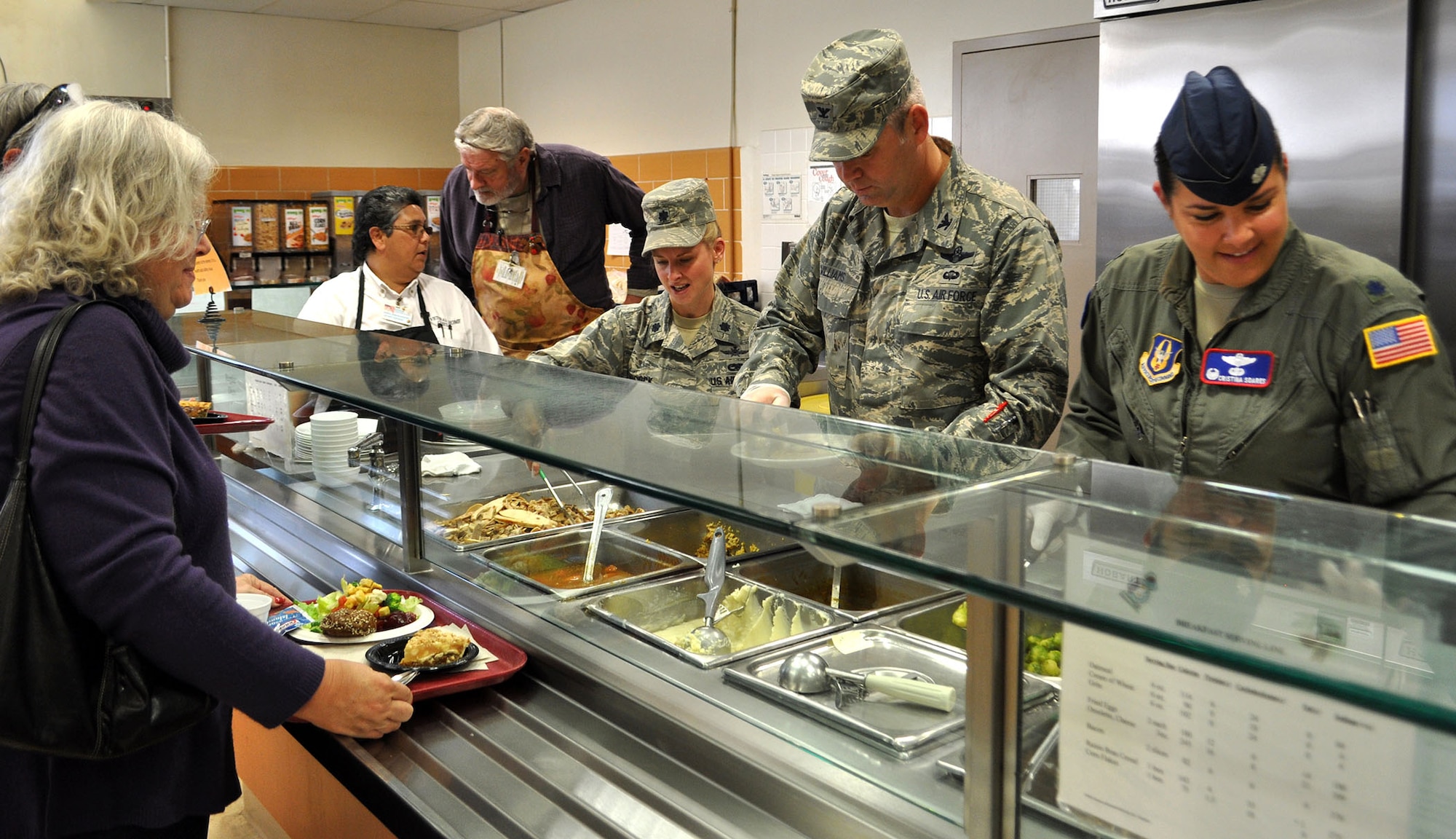 TRAVIS AIR FORCE BASE, Calif. -- Volunteers from the 349th Air Mobility Wing serve up the Thanksgiving meal at the Yountville Veterans Home during their yearly trek to spend the holiday with our veterans. From the left: Lt. Col. Arianne Babcock, 749th Aircraft Maintenance Squadron, Col. Patrick Williams, 349th AMW vice commander, and Lt. Col. Christina Soares, 79th Air Refueling Squadron commander help fill the plates with turkey and all the trimmings. (U.S. Air Force photo/SMSgt. (ret) Ellen Hatfield)
