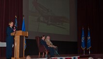 Second Lt. Christen Ornella, 90th Missile Wing Public Affairs, recounts the story of 1st Lt. (Ret.) Paul Kniss’s evacuation of his damaged P-51 Mustang and subsequent capture during the Korean Conflict May 31, 1952, to the audience, including his friends and F.E. Warren personnel. A medal presentation ceremony was held for Kniss in the F.E. Warren Air Force Base, Wyo., Theater Dec. 5, 2013. Instead of receiving a Purple Heart medal upon his return to friendly forces after approximately a year-and-a-half of captivity, Kniss opted to head straight home to his wife, and received the Purple Heart as well a Prisoner of War medal 61 years after he earned them. (U.S. Air Force photo by Airman 1st Class Jason Wiese)