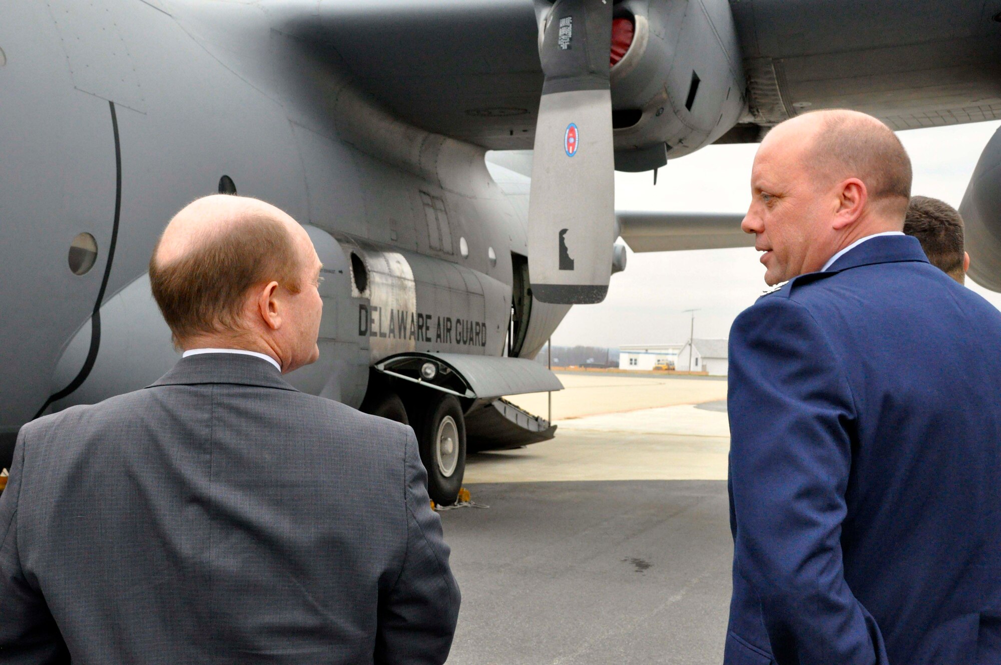 U.S. Air Force Col. Dave Byerly, vice commander, 166th Airlift Wing, Delaware Air National Guard, and U.S. Sen. Chris Coons (D-Del.) discuss the C-130 aircraft and the mission of the Delaware ANG prior to a tour of a C-130H on Dec. 2, 2013 at the New Castle ANG Base, Del. (U.S. Army National Guard photo by Staff Sgt. Wendy McDougall)