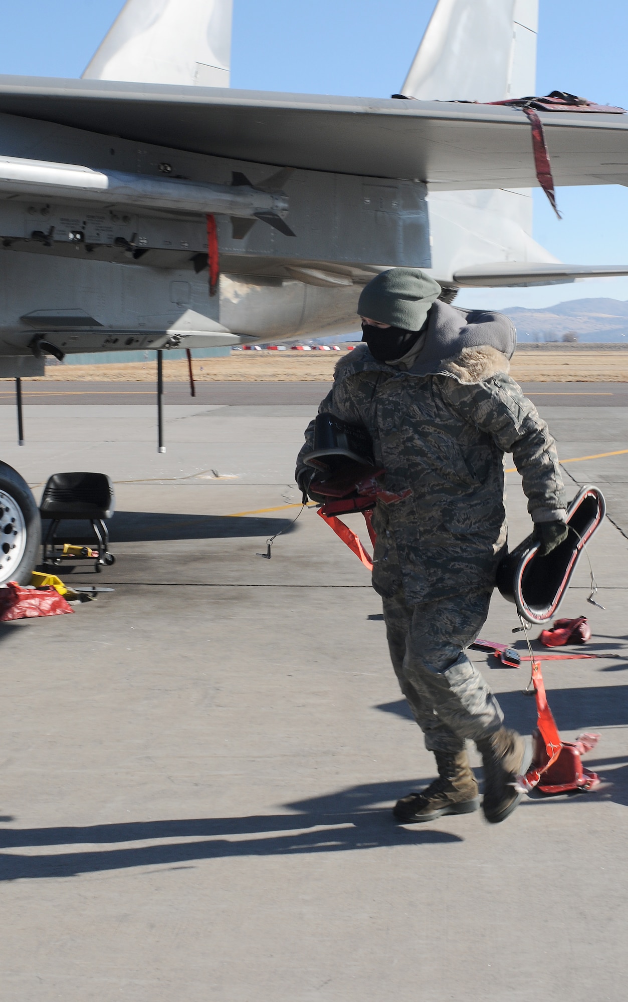 Airman First Class Theresa Anderson, 173rd Fighter Wing F-15C crew chief, bundles up against the harsh wind and biting cold on the flight line at Kingsley Field, Klamath Falls, Ore. while she recovers F-15s from the 144th Fighter Wing, Calif. Air National Guard, January 4, 2013. Dec. 4, 2013. The 173rd is teaming up with the 144th to increase the number of students trained in order to meet an increased demand for F-15 pilots at the 144th. (U.S. Air National Guard photo by Master Sgt. Jennifer Shirar/released)