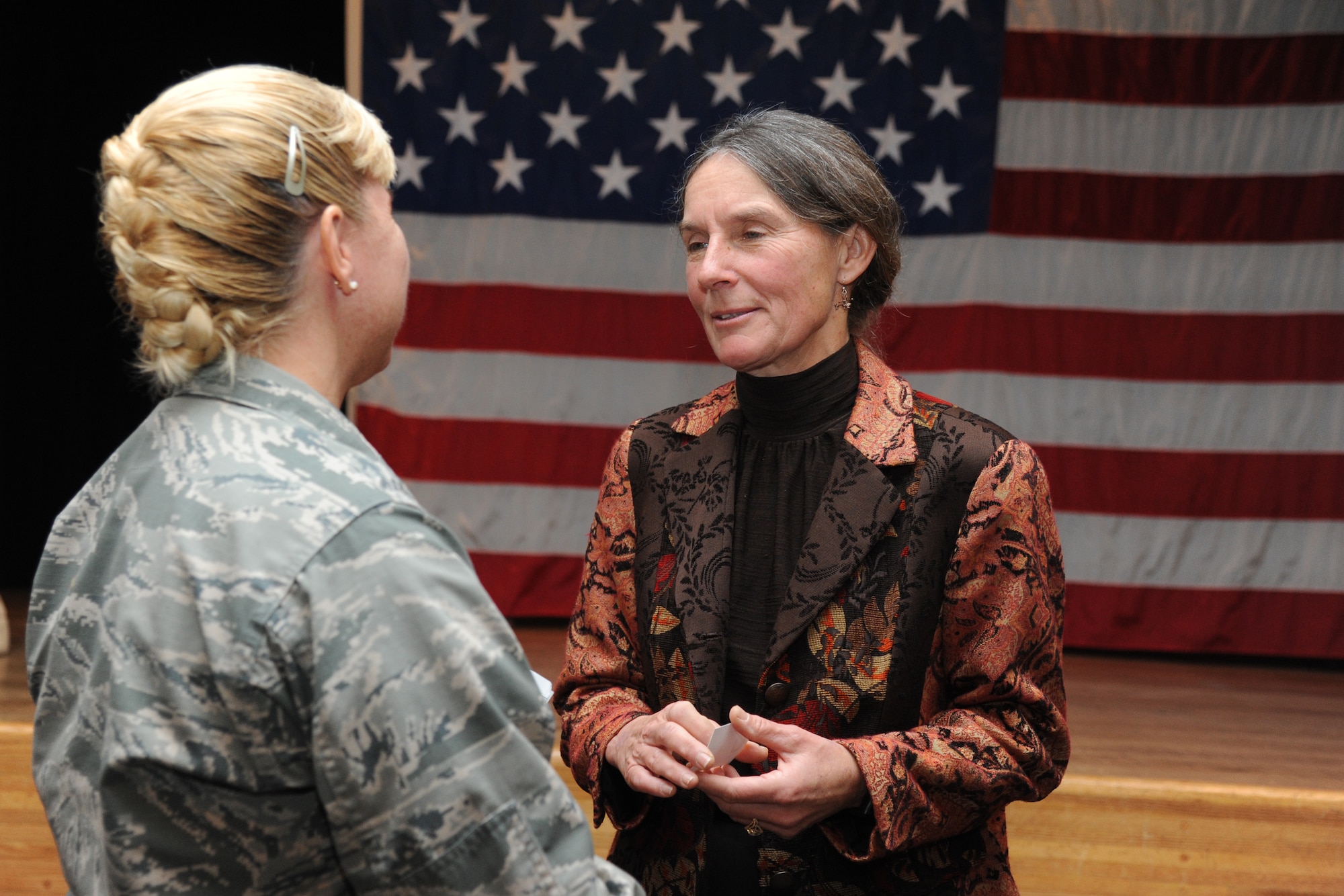 Lt. Col. Dorene Ross, 335th Training Squadron commander, speaks with Retired Army Brig. Gen. Rhonda Cornum, following a special program where Cornum shared her experience as a prisoner of war during the Persian Gulf conflict with Keesler personnel Dec. 5, 2013, at the Keesler Medical Center.  During the Persian Gulf War, Cornum’s helicopter was shot down while on a search and rescue mission. She suffered two broken arms, a gunshot wound in the back and was captured by enemy forces. Cornum is the wife of Brig. Gen. Kory Cornum, 81st Medical Group commander. (U.S. Air Force photo by Kemberly Groue)