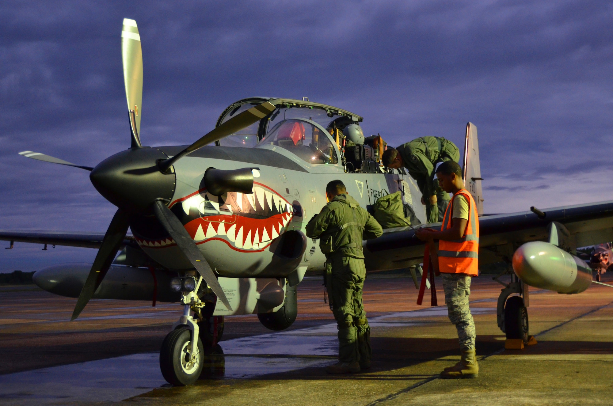A Dominican Republic air force pilot and maintenance airman inspect an A-29 Super Tucano for a nighttime flight as part of an exercise to detect and track illegal drug traffic Dec. 4, 2013. The exercise is part of the Sovereign Skies Program, an initiative between the U.S., Colombian, and Dominican Republic air forces to share best-practices on procedures to detect, track and intercept illegal drugs moving north from South America. Since the program’s inception, the number of aircraft suspected to traffic drugs through the Dominican Republic dropped from more than 100 annually to nearly zero. (U.S. Air Force photo by Capt. Justin Brockhoff/Released)


