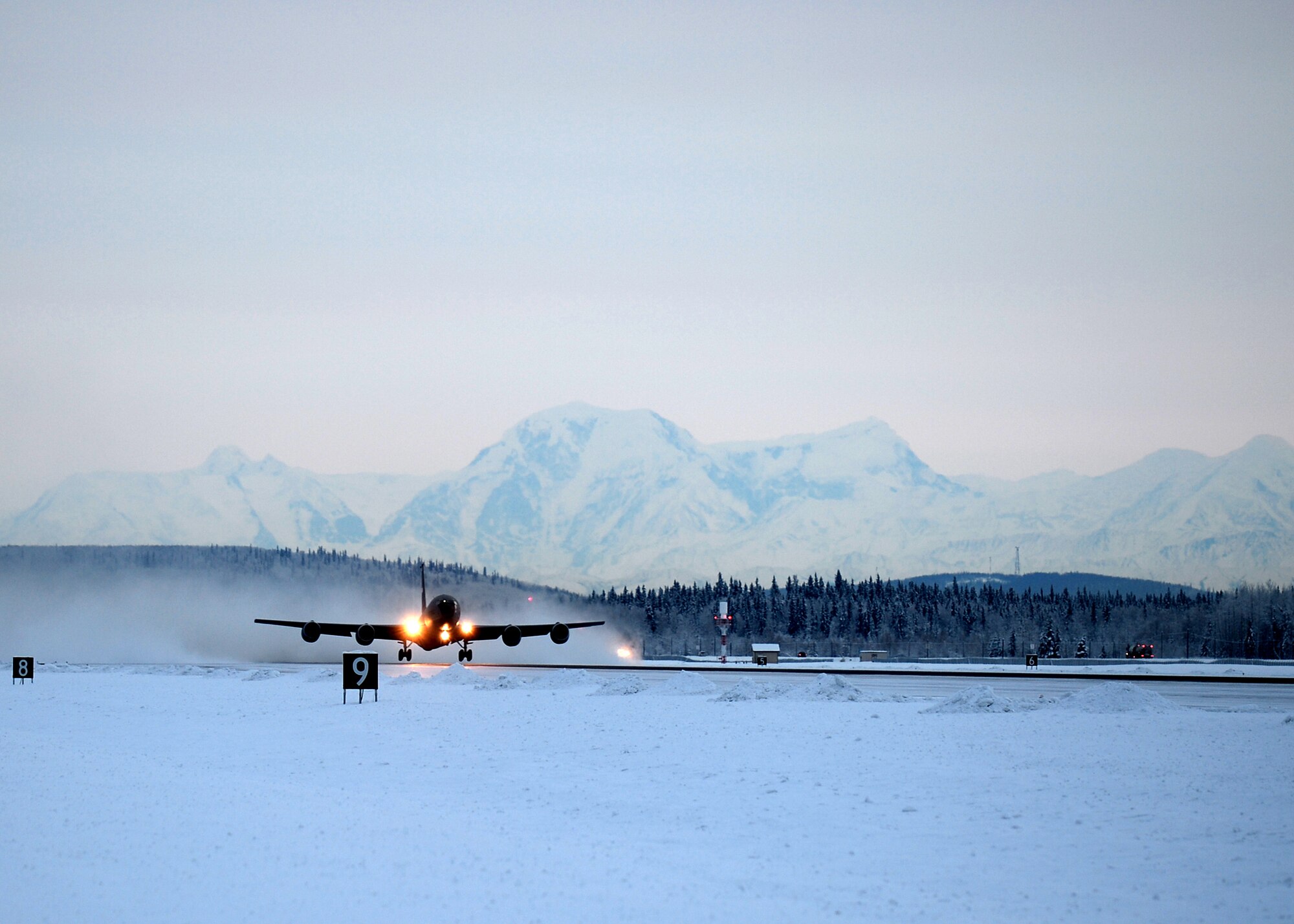 A KC-135 Stratotanker from the 168th Air Refueling Wing takes off Dec. 3, 2013 from Eielson Air Force Base, Alaska. An ice cloud is left behind in the sub-zero temperatures as the sun drops in early afternoon. (U.S. Air Force photo by Senior Airman Shawn Nickel/Released) 
