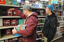 (From left) University of North Dakota students, Garrett Stitt and Ryan Lengling shop for holiday lights at a local hardware store in Grand Forks, N.D., Dec. 5, 2013. Fire safety experts say there are several factors to consider when buying or using holiday lights. (U.S. Air Force photo/Staff Sgt. Luis Loza Gutierrez) 
