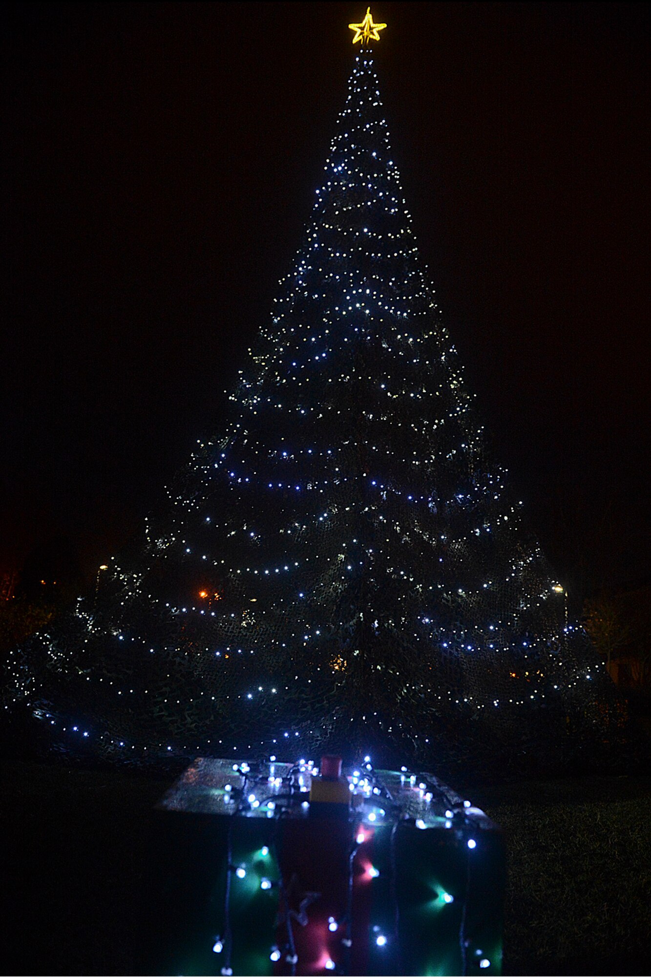 The Royal Air Force Lakenheath, England, Christmas tree stands lit after a ceremony held Dec. 6, 2013. The 48th Fighter Wing kicked off a new holiday tradition by building a Christmas tree rather than buying one, saving the wing $5,600. The tree-lighting ceremony also included caroling, cookies, hot chocolate and a visit from Santa Claus.  (U.S. Air Force photo by Airman 1st Class Trevor T. McBride/Released)