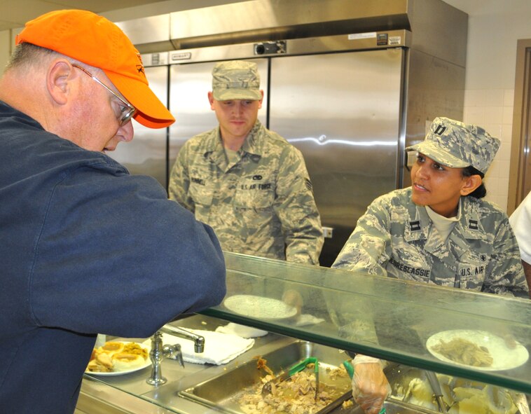 Senior Amn Steven Bunnell, 60th MXS, serves up Thanksgiving dinner on the line in the Main Dining Room of the Yountville Veterans Home (U.S. Air Foce photo/Ellen Hatfield)