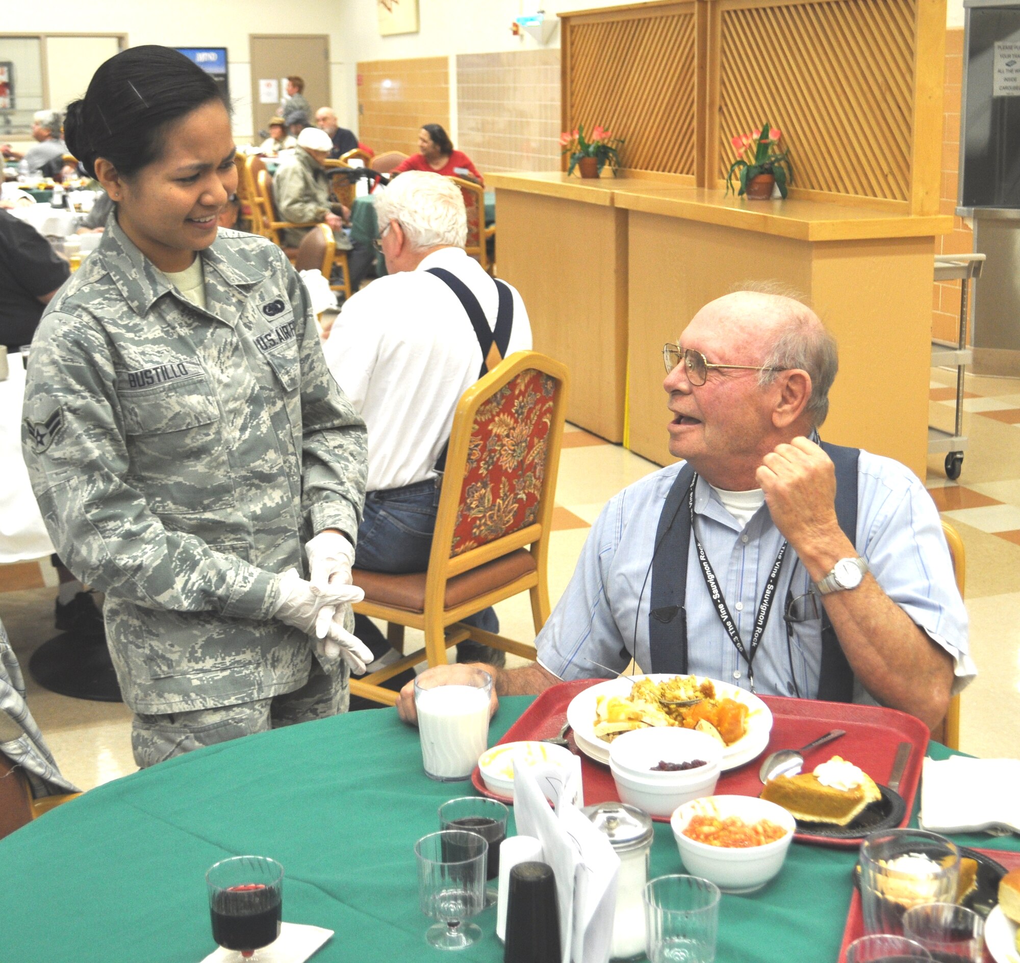 Airman 1st Class Dianne Bustillo, 60th LRS, chats with a veteran over Thanksgiving dinner at the California Veterans Home, Yountville. (U.S. Air Foce photo/Ellen Hatfield)