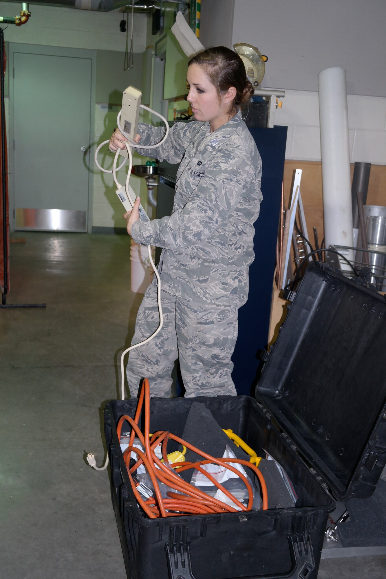 Cadet 1st Class Meredith Wilmer unpacks FALCONSAT-6 materiel after its return from New Mexico where it was tested to withstand forces of a rocket launch. 
