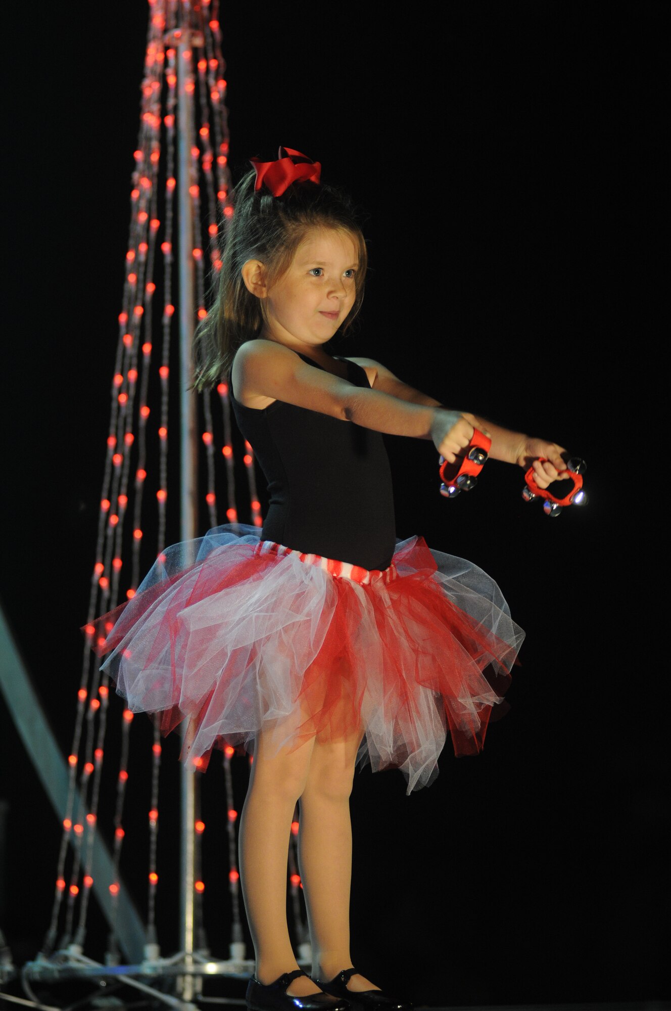 The daughter of Staff Sgt. Nathen Jenkins, 336th Training Squadron, hits her final jazz dance performance pose she learned from the Keesler Youth Center’s creative movement dance class during Keesler’s annual Christmas in the Park celebration Dec. 4, 2013, at marina park, Keesler Air Force Base, Miss. The event, hosted by Outdoor Recreation, included a tree lighting ceremony, tour train rides, holiday music, cookie decorating, visits with Santa and free food and beverages. (U.S. Air Force photo by Kemberly Groue)