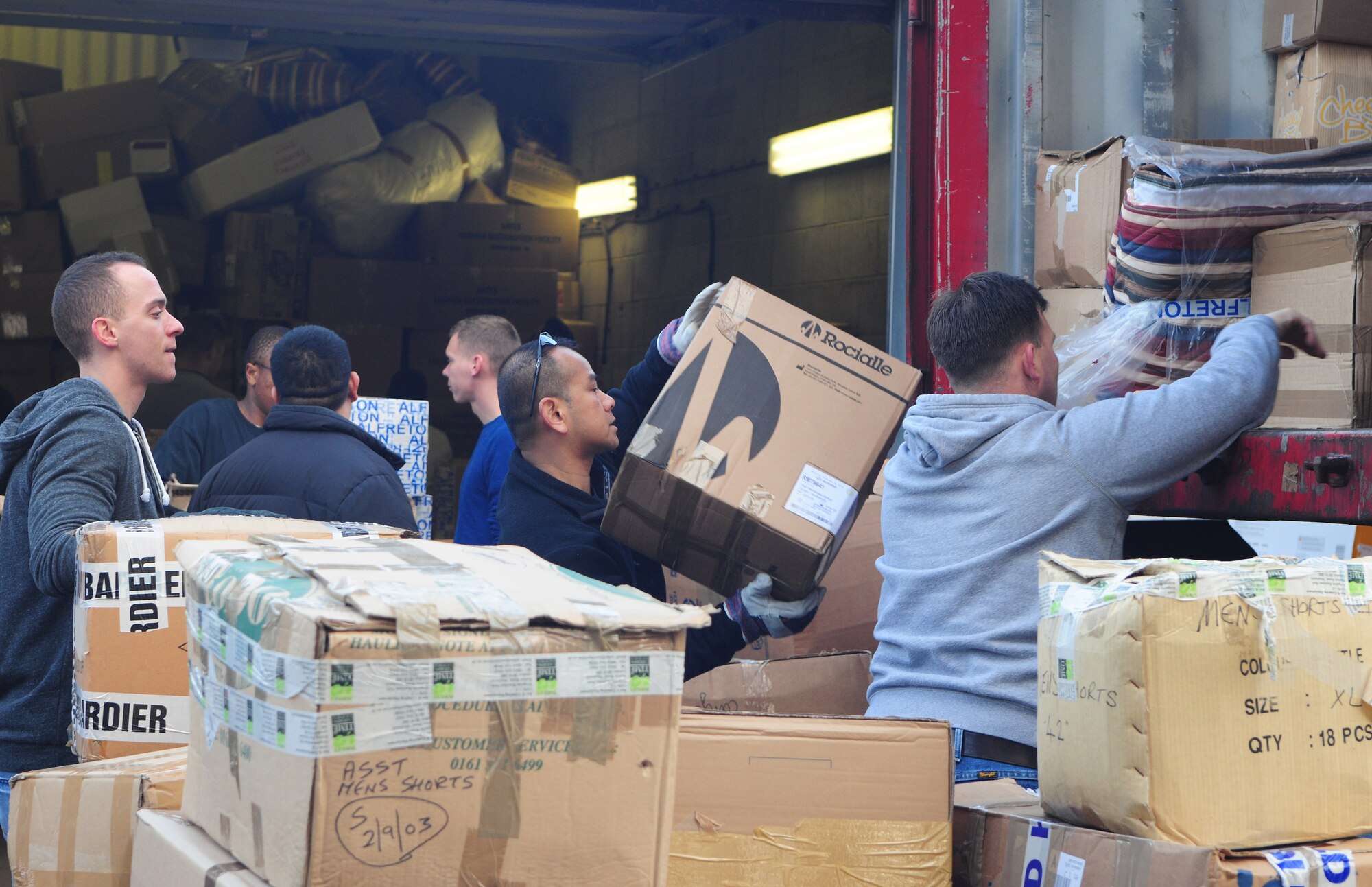 Volunteers help load relief supplies onto a shipping container Nov. 27, 2013, in Littleport, England. Approximately 400 boxes of supplies including food, blankets, medical items and toiletries were collected to help victims of Typhoon Haiyan, which happened recently in the Philippines. (U.S. Air Force photo by Staff Sgt. Rachel Waller/Released)