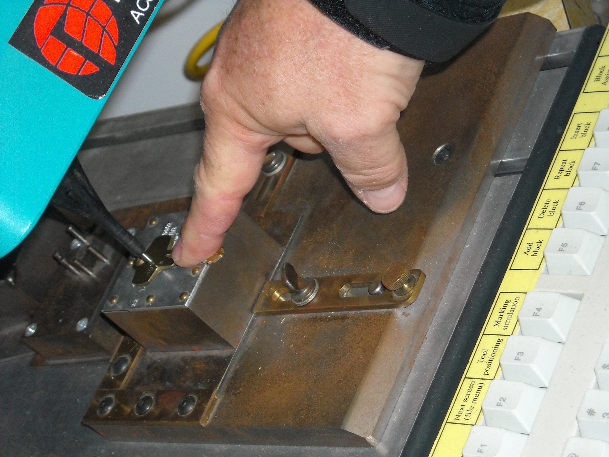 Among the equipment Barry Yuill uses in his locksmith shop is a machine used to create new keys for base customers. (U.S. Air Force photo by Jenny Gordon)