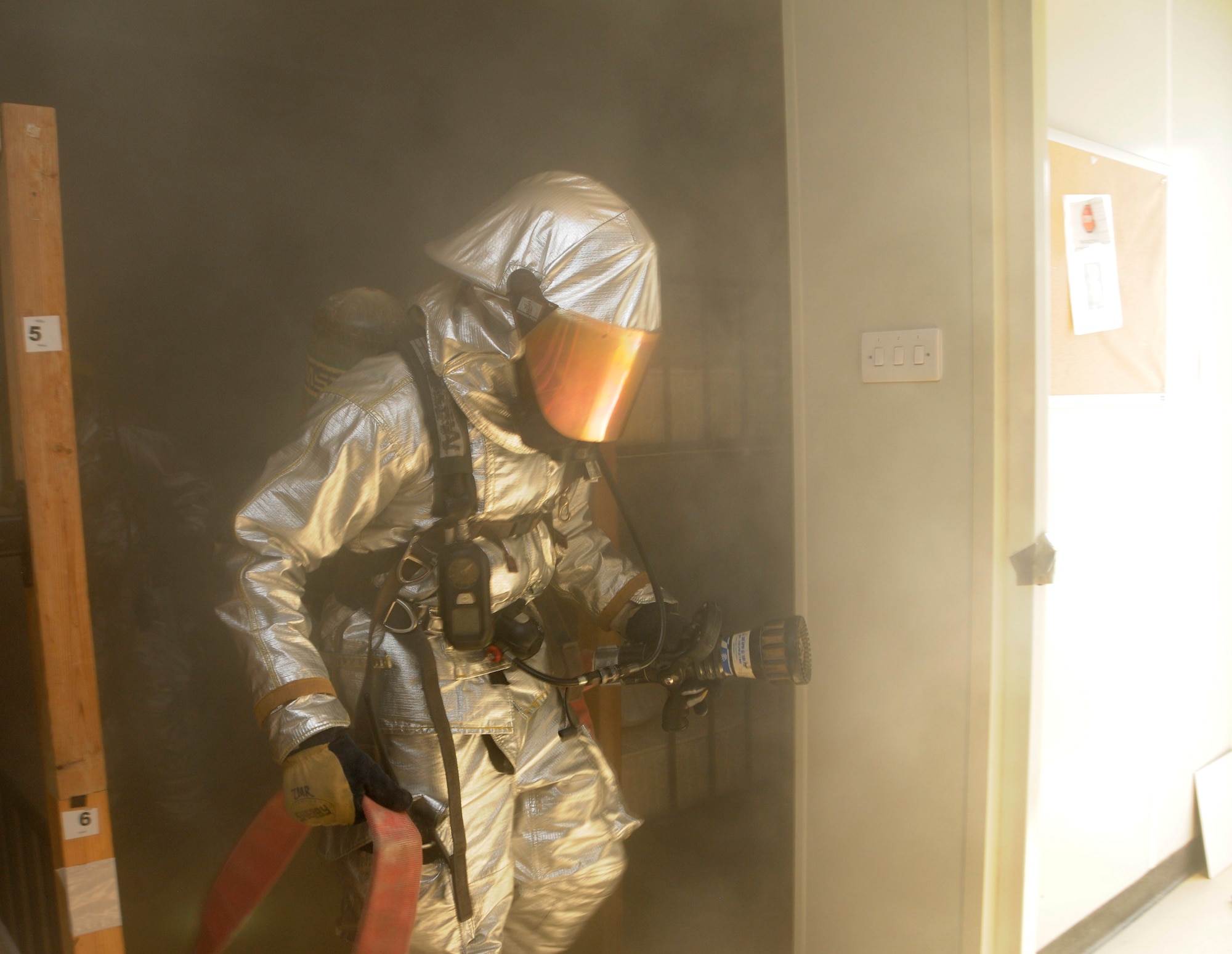 A member of the 379th Expeditionary Civil Engineer Squadron clears a room during a fire attack and search and rescue tactics exercise at the 379th Air Expeditionary Wing in Southwest Asia, Dec. 5, 2013.  The 379th ECES fire department conducts monthly training to keep crews proficient, safe and ready to handle any fire-related situation. (U.S. Air Force photo/Senior Airman Hannah Landeros)