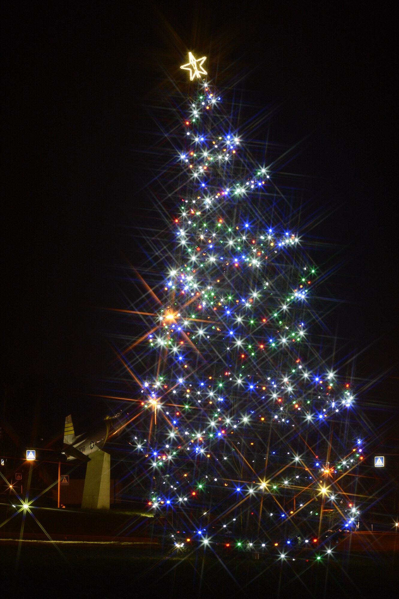 SPANGDAHLEM AIR BASE, Germany – The Spangdahlem Air Base holiday tree is illuminated during a lighting ceremony at Club Eifel Dec. 5, 2013. High winds forced the ceremony to be held inside the club. (U.S. Air Force photo by Staff Sgt. Christopher Ruano/Released)