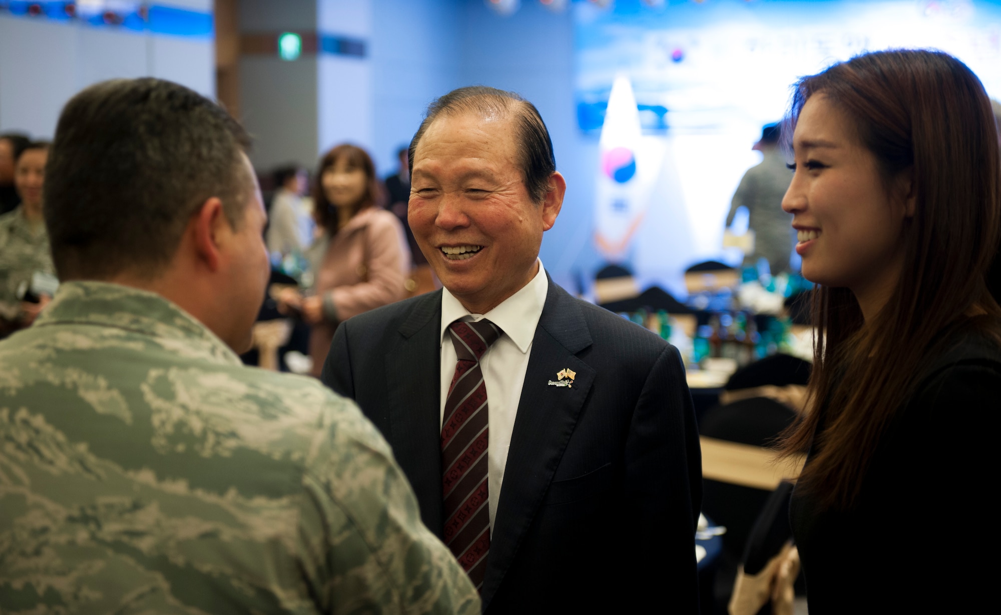 Moon Dong-shin, Gunsan City mayor, speaks to an 8th Fighter Wing Airman during an appreciation event in Gunsan City, Republic of Korea, Dec. 5, 2013. The Korean and American Gunsan Alliance group held an event in recognition of the cooperation and support between the Gunsan community and Kunsan Air Base. (U.S. Air Force photo by Senior Airman Armando A. Schwier-Morales/Released)