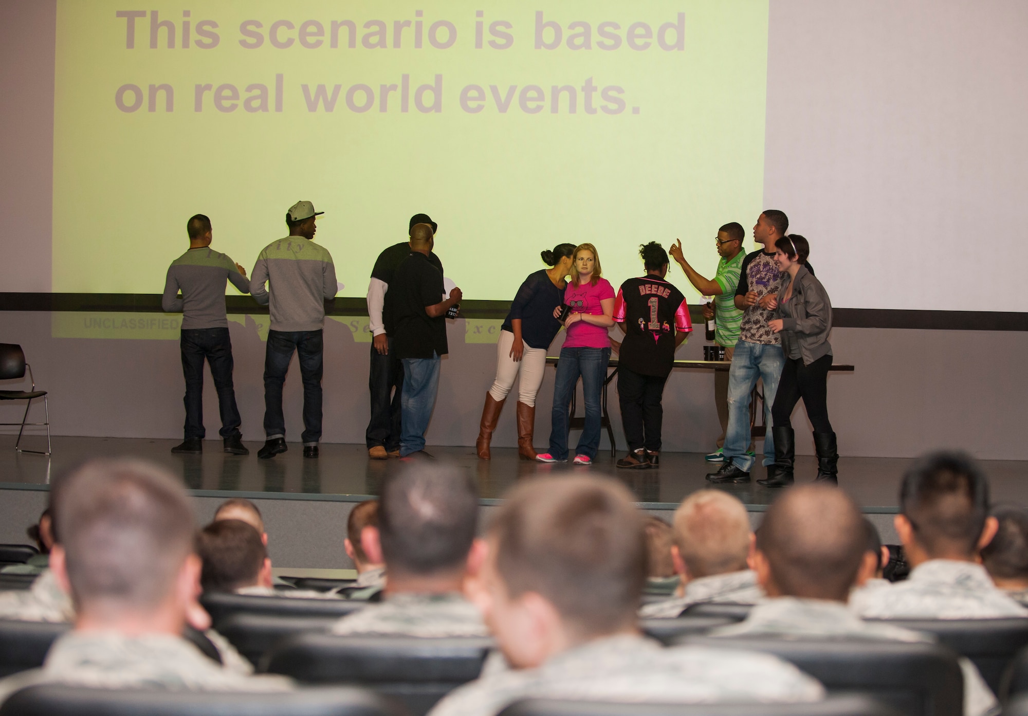 Actors from the Kunsan Sexual Assault Theater Group perform a sexual assault prevention and response scenario during an all call at Kunsan Air Base, Republic of Korea, Dec. 6, 2013. The wing commander held all calls featuring a SAT-G performance, SAPR training and a question and answer session, as part of a continuing effort to combat sexual assault and promote a culture change. (U.S. Air Force photo by Senior Airman Armando A. Schwier-Morales/Released)