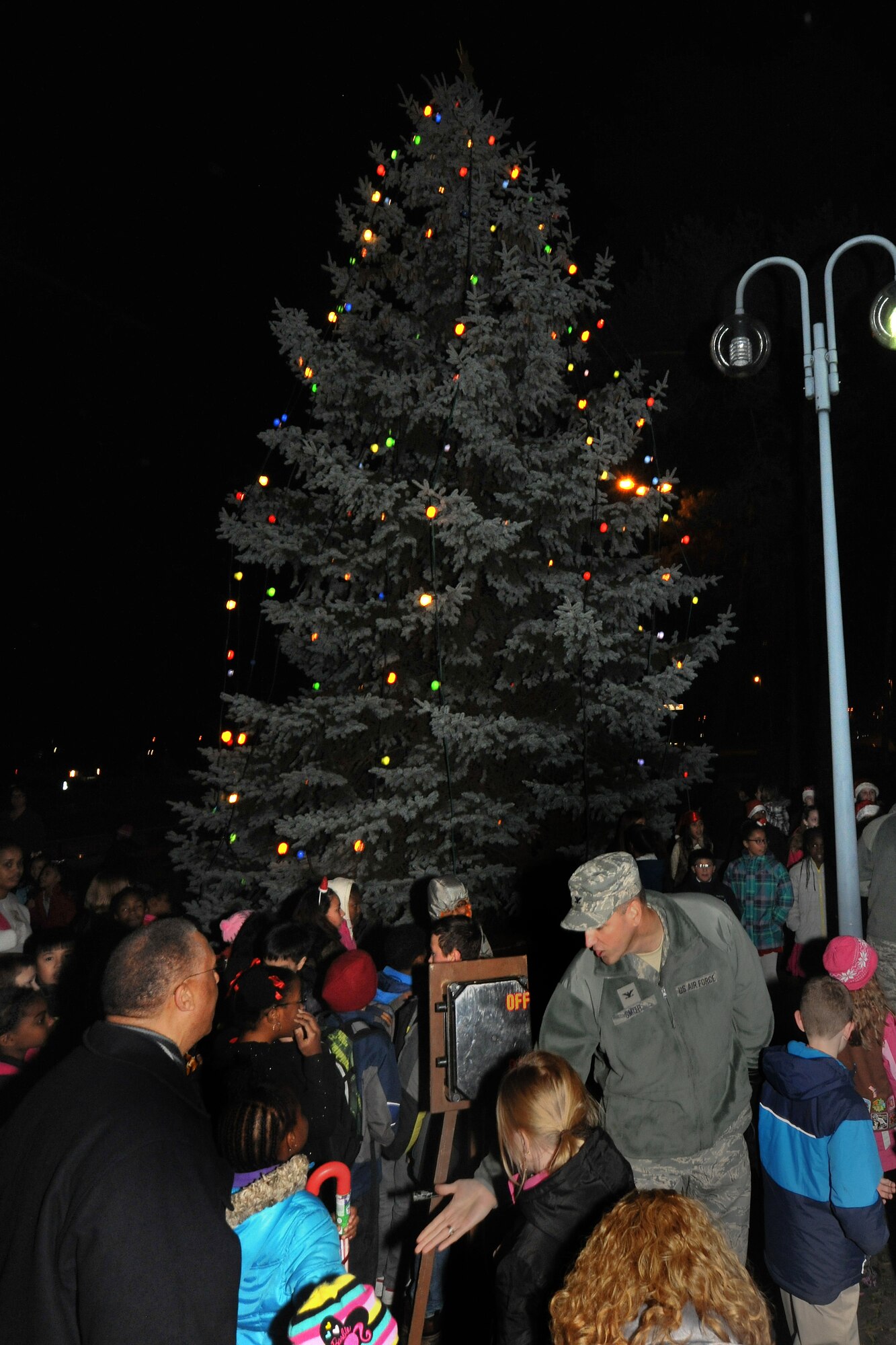 Kaiserslautern Military Community members participated in the lighting of the Christmas tree on Kapuan Air Station, Germany, Dec. 03, 2013. The ceremony included seasonal music, the tree lighting and holiday treats. (U.S. Air Force photo/Senior Airman Chris Willis)