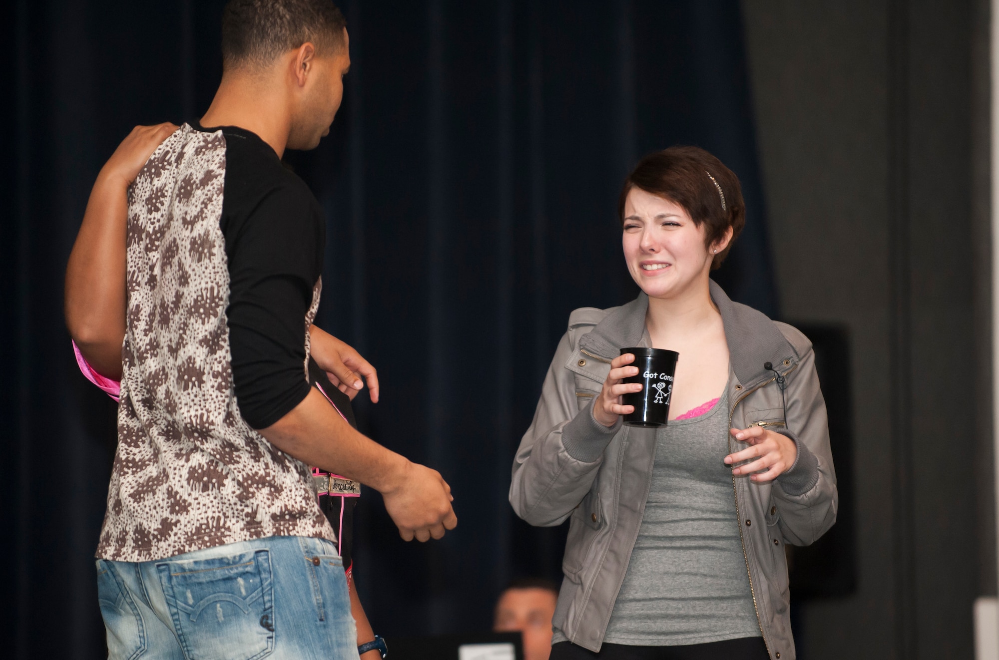 Airman 1st Class Marina Clark, 8th Civil Engineer Squadron and Sexual Assault Theater Group actor , acts out a scene during a sexual assault prevention and response performance for Airmen at Kunsan Air Base, Republic of Korea, Dec. 6, 2013. The wing commander held all calls featuring a SAT-G performance, SAPR training and a question and answer session, as part of a continuing effort to combat sexual assault and promote a culture change. (U.S. Air Force photo by Senior Airman Armando A. Schwier-Morales/Released)