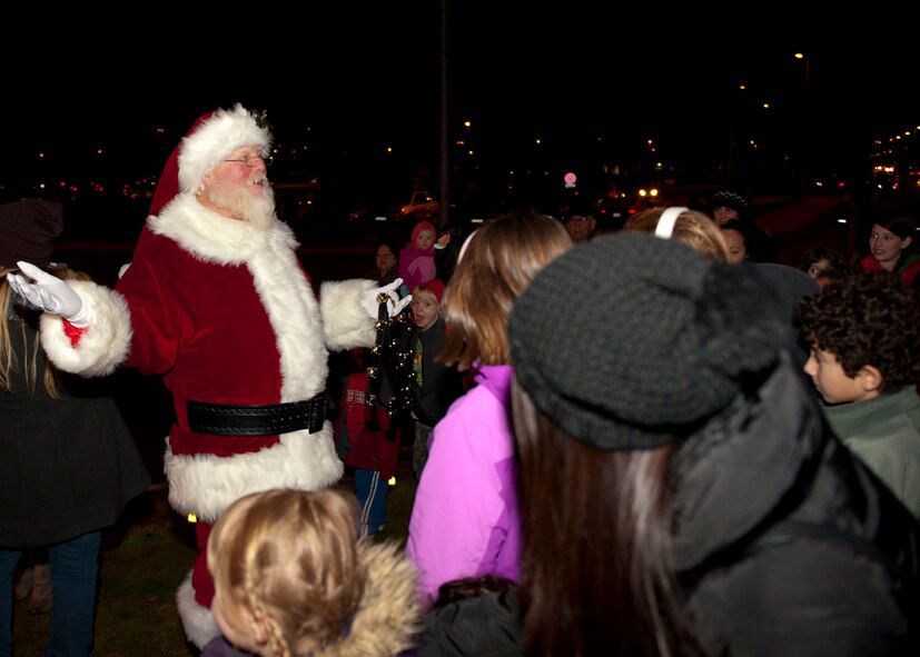 Santa Claus lets out a jolly “Ho, ho, ho” as Ramstein children run up to him screeming with joy during the 2013 Ramstein Christmas Tree Lighting ceremony, Dec. 3, 2013, Ramstein Air Base, Germany. Santa was on a mission that is different than the ones Ramstein members are used to. His mission was to put smiles on all the children’s faces. Mission success! (U.S. Air Force photo/Staff Sgt. Kris Levasseur)