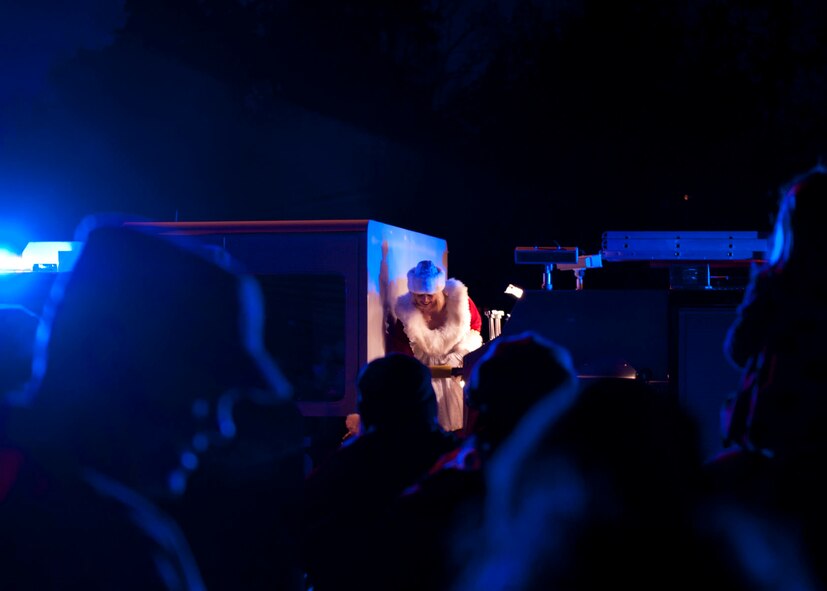 Mrs. Claus steps off a fire truck to greet children during the 2013 Ramstein Christmas Tree Lighting ceremony, Dec. 3, 2013, Ramstein Air Base, Germany. Though Mrs. Claus said she was there to see all the smiling faces, she also had an ulterior motive … to make sure Santa didn’t eat too many cookies. (U.S. Air Force photo/Staff Sgt. Kris Levasseur)