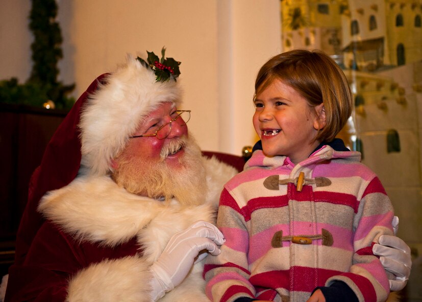 Rose Taylor, daughter of Lt. Col. Patrick and Terry Taylor, giggles with joy as she prepares to tell Santa Claus what she wants this year after the 2013 Ramstein Christmas Tree Lighting ceremony, Dec. 3, 2013, Ramstein Air Base, Germany. Taylor had several things she wanted this year, although her two front teeth may have not made the cut. (U.S. Air Force photo/Staff Sgt. Kris Levasseur)