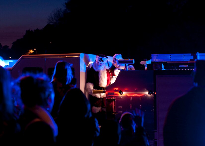 Ramstein children smile with excitement while waiting for Santa Claus to dismount his preferred on-base ride during the 2013 Ramstein Christmas Tree Lighting ceremony, Dec. 3, 2013, Ramstein Air Base, Germany. Though not as strong as reindeer power, the horse power of the fire truck was more than enough to get Santa and Mrs. Claus to the ceremony in time to greet the children. (U.S. Air Force photo/Staff Sgt. Kris Levasseur)