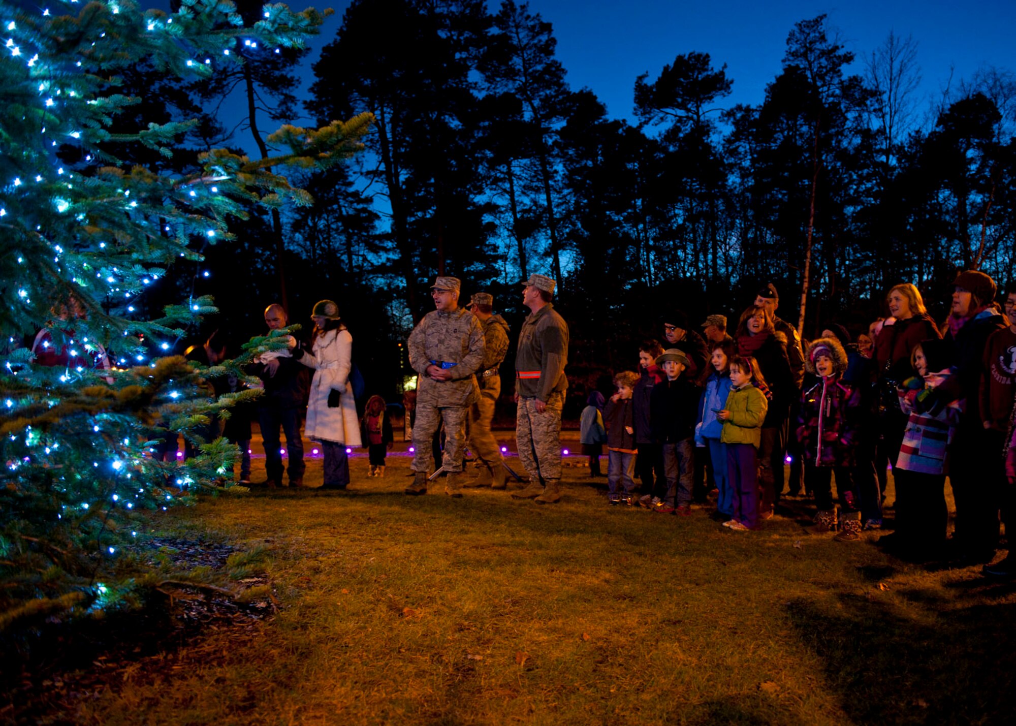 Ramstein members witness the first glow of the lights during the 2013 Ramstein Christmas Tree Lighting ceremony, Dec. 3, 2013, Ramstein Air Base, Germany. Ramstein families gathered to celebrate the holiday season during this signature holiday event. (U.S. Air Force photo/Staff Sgt. Kris Levasseur)