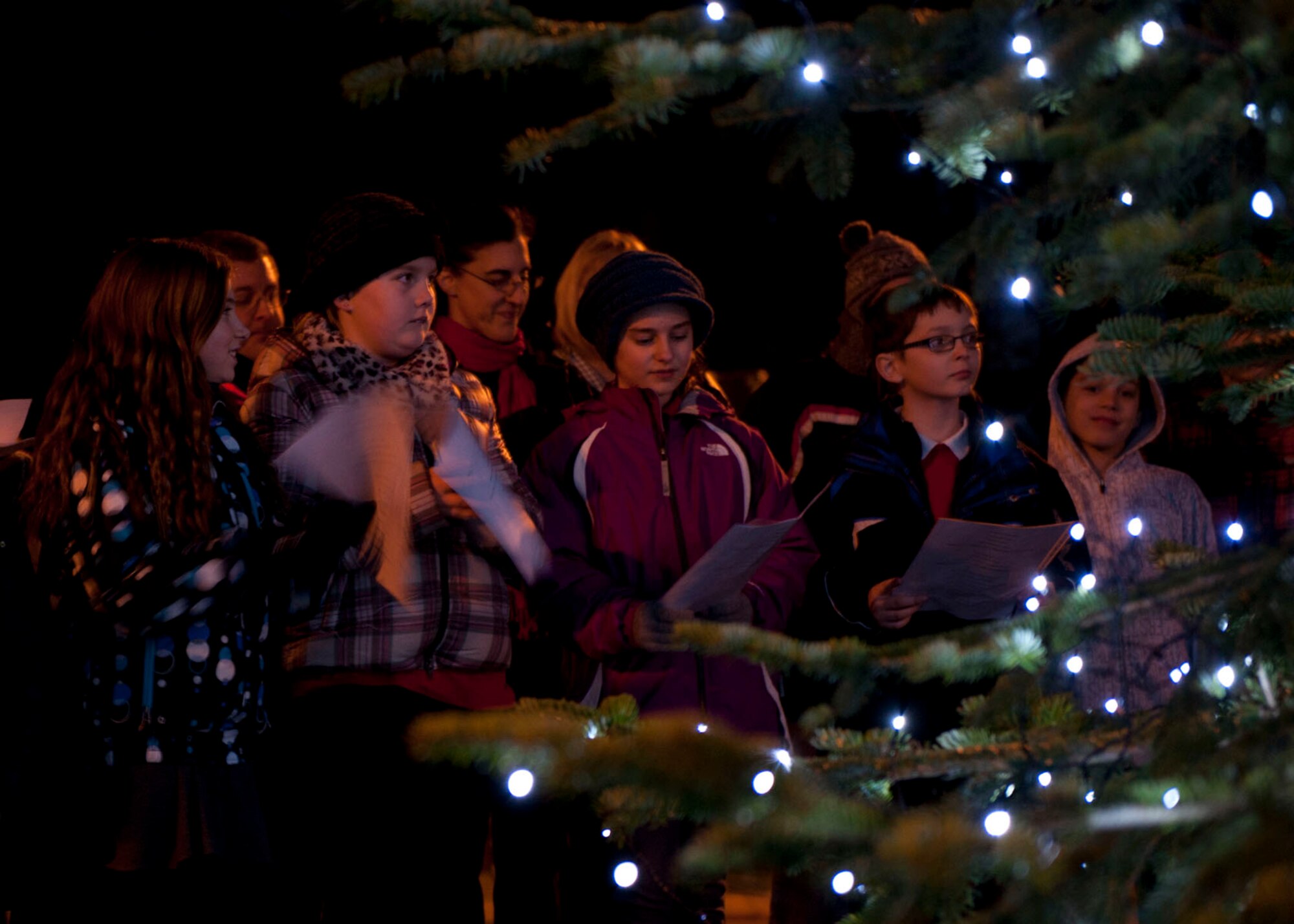 Ramstein children sing Christmas carols for the crowd during the 2013 Ramstein Christmas Tree Lighting ceremony, Dec. 3, 2013, Ramstein Air Base, Germany. The children and their families gathered to celebrate the holiday season during this signature holiday event. (U.S. Air Force photo/Staff Sgt. Kris Levasseur)