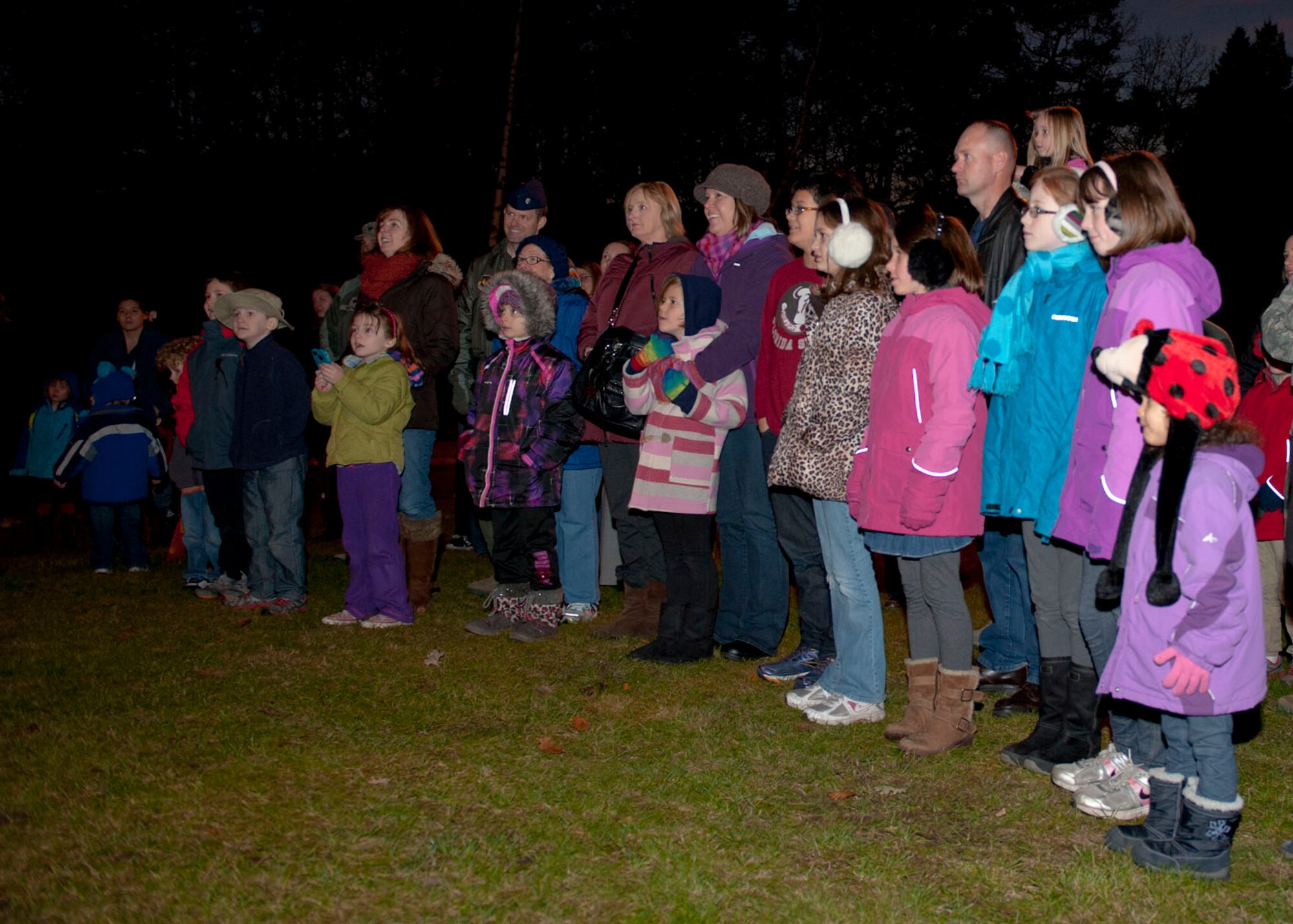 Ramstein families wait for the lights to switch on during the 2013 Ramstein Christmas Tree Lighting ceremony, Dec. 3, 2013, Ramstein Air Base, Germany. The families gathered together and bared the chilly night to witness the tree lighting. (U.S. Air Force photo/Staff Sgt. Kris Levasseur)