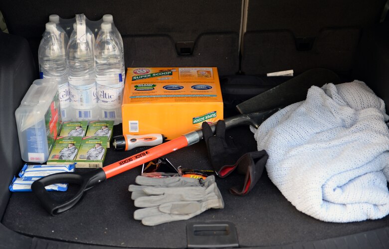 SPANGDAHLEM AIR BASE, Germany—A driver stocks the trunk of his car with safety supplies in preparation for the upcoming winter months Dec. 6, 2013. Some of the items include: a shovel, kitty litter, thermal blankets, water, hand warmers and a flashlight. (U.S. Air Force photo by Senior Airman Alexis Siekert)