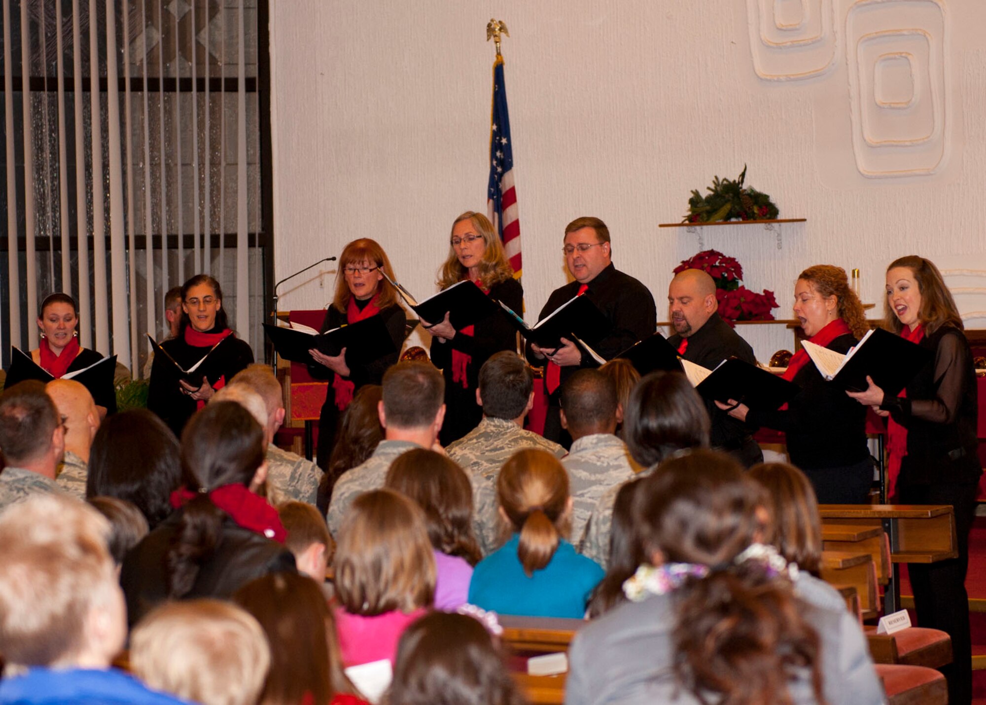 Members of the Blackbirds Chamber Choir from the Rheinland-Pfalz International Choir sing Christmas carols for the crowd during the 2013 Ramstein Christmas Tree Lighting ceremony, Dec. 3, 2013, Ramstein Air Base, Germany. The choir set the tone and helped Ramstein families celebrate the holiday season. (U.S. Air Force photo/Staff Sgt. Kris Levasseur)