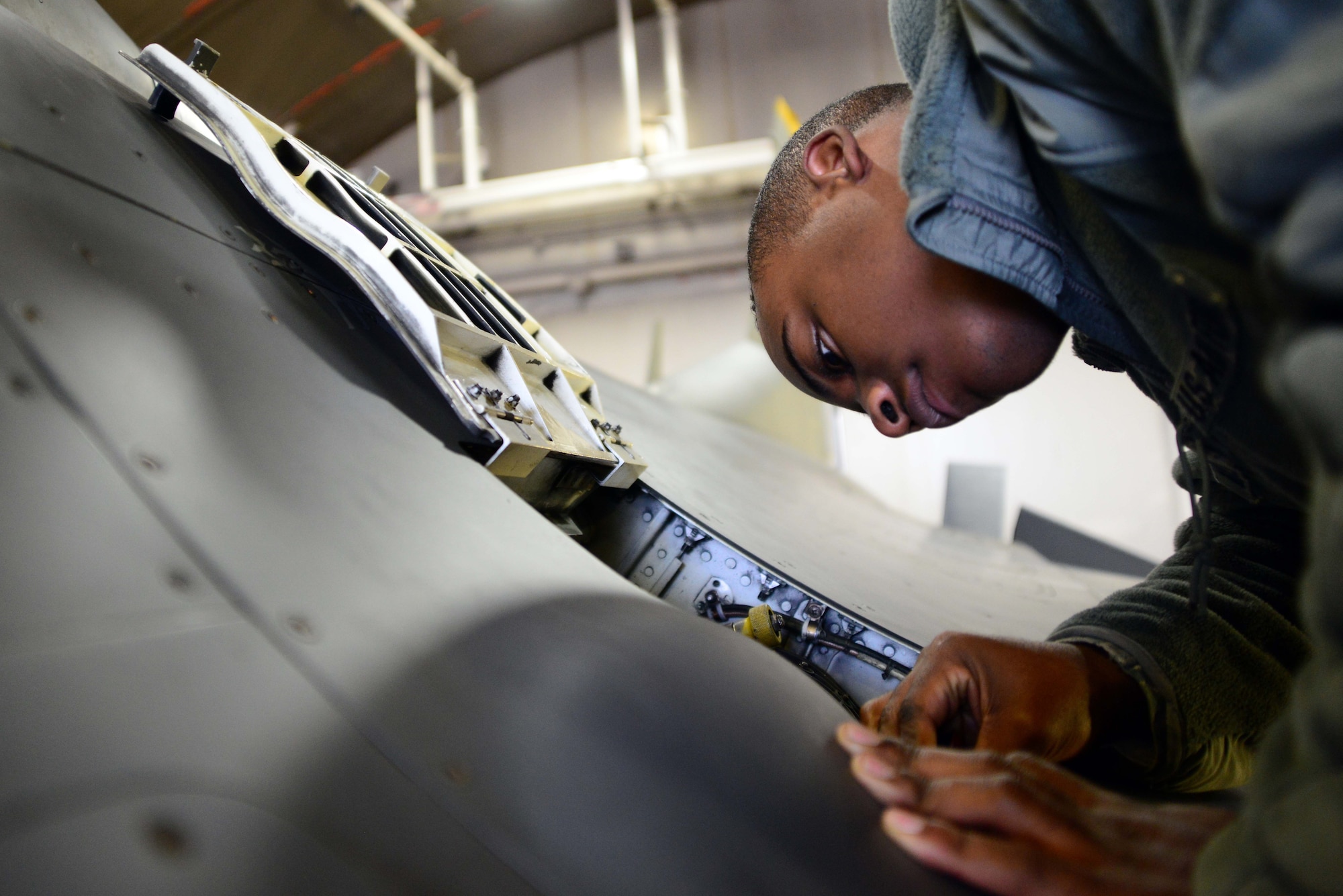Senior Airman James Miller, 35th Aircraft Maintenance Squadron weapons systems technician, tightens a U.S. Air Force F-16 Fighting Falcon’s M61 A1 Gatling Gun lubricator at Misawa Air Base, Japan, Dec. 6, 2013. The lubricator aids the gun to move freely and prevent any binding while in action. (U.S. Air Force photo by Senior Airman Derek VanHorn)
