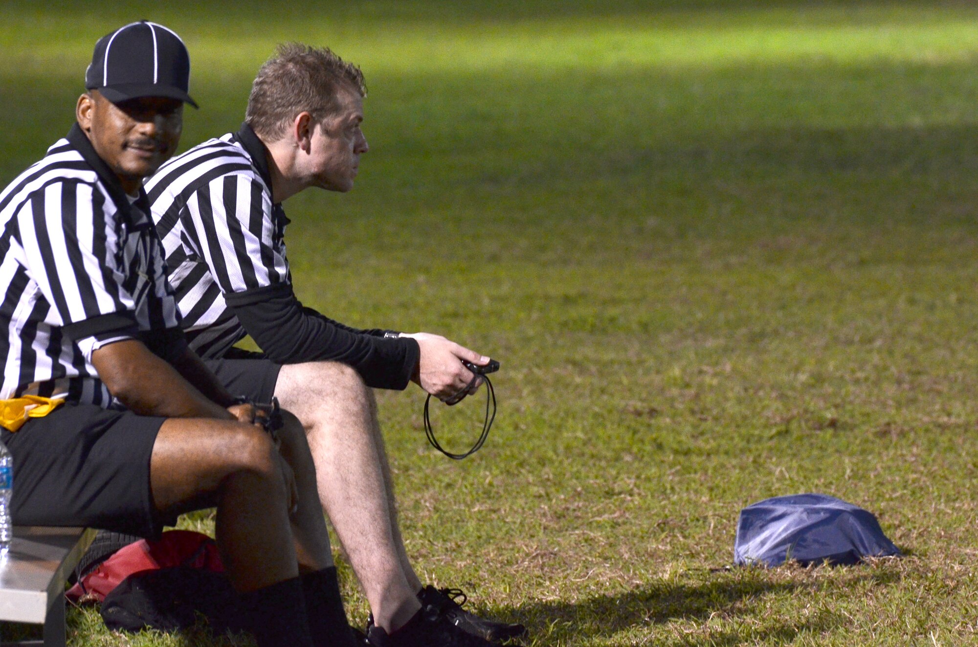 Referees wait for an intramural flag football game to start Dec. 4, 2013, on Andersen Air Force Base, Guam. 94th Army Air and Missile Defense Command practiced with Helicopter Sea Combat Squadron 25to prepare for future games. (U.S. Air Force photo by Airman 1st Class Mariah Haddenham/Released)