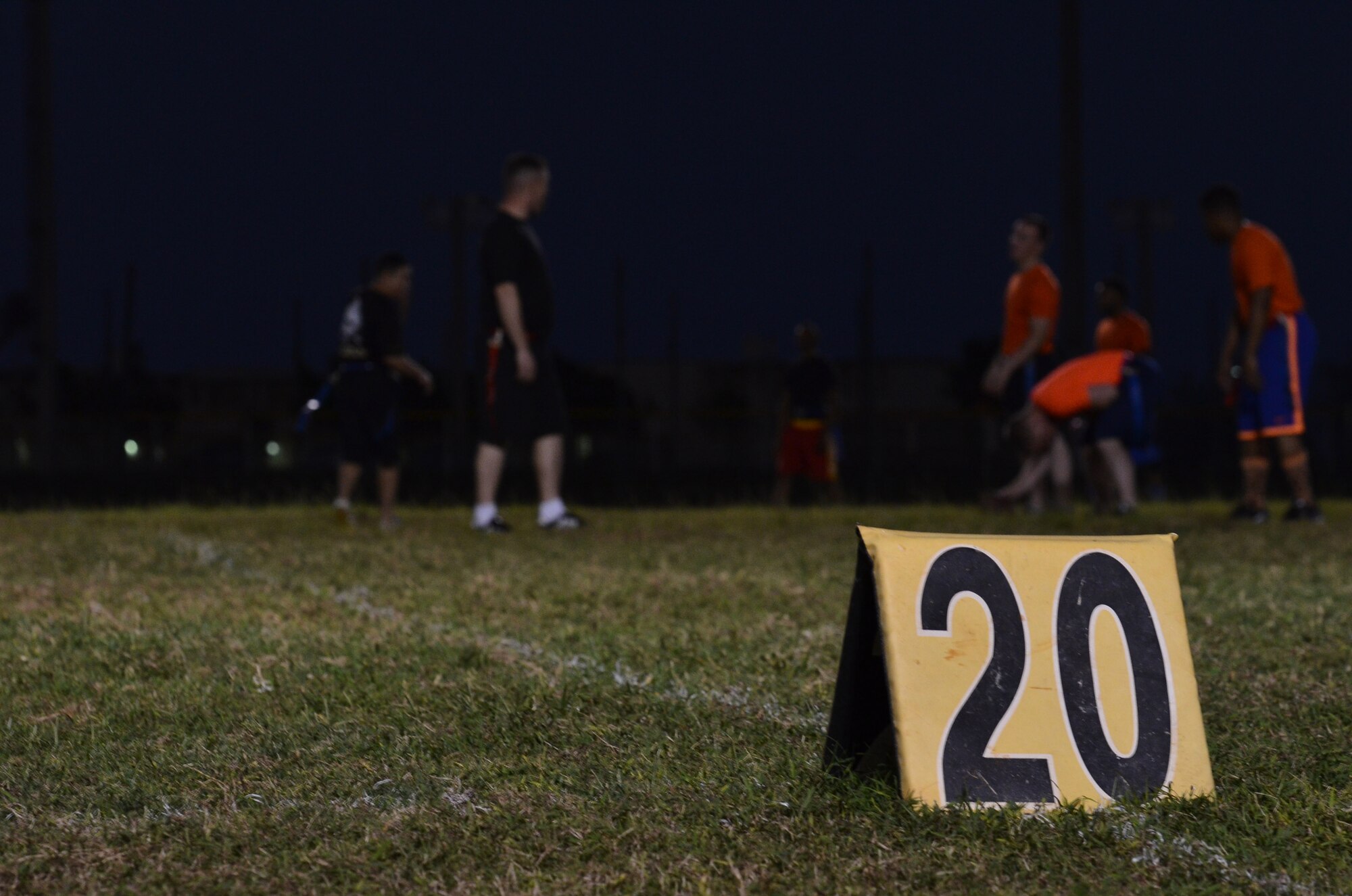 Referees wait for an intramural flag football game to start Dec. 4, 2013, on Andersen Air Force Base, Guam. 94th Army Air and Missile Defense Command practiced with Helicopter Sea Combat Squadron 25to prepare for future games. (U.S. Air Force photo by Airman 1st Class Mariah Haddenham/Released)