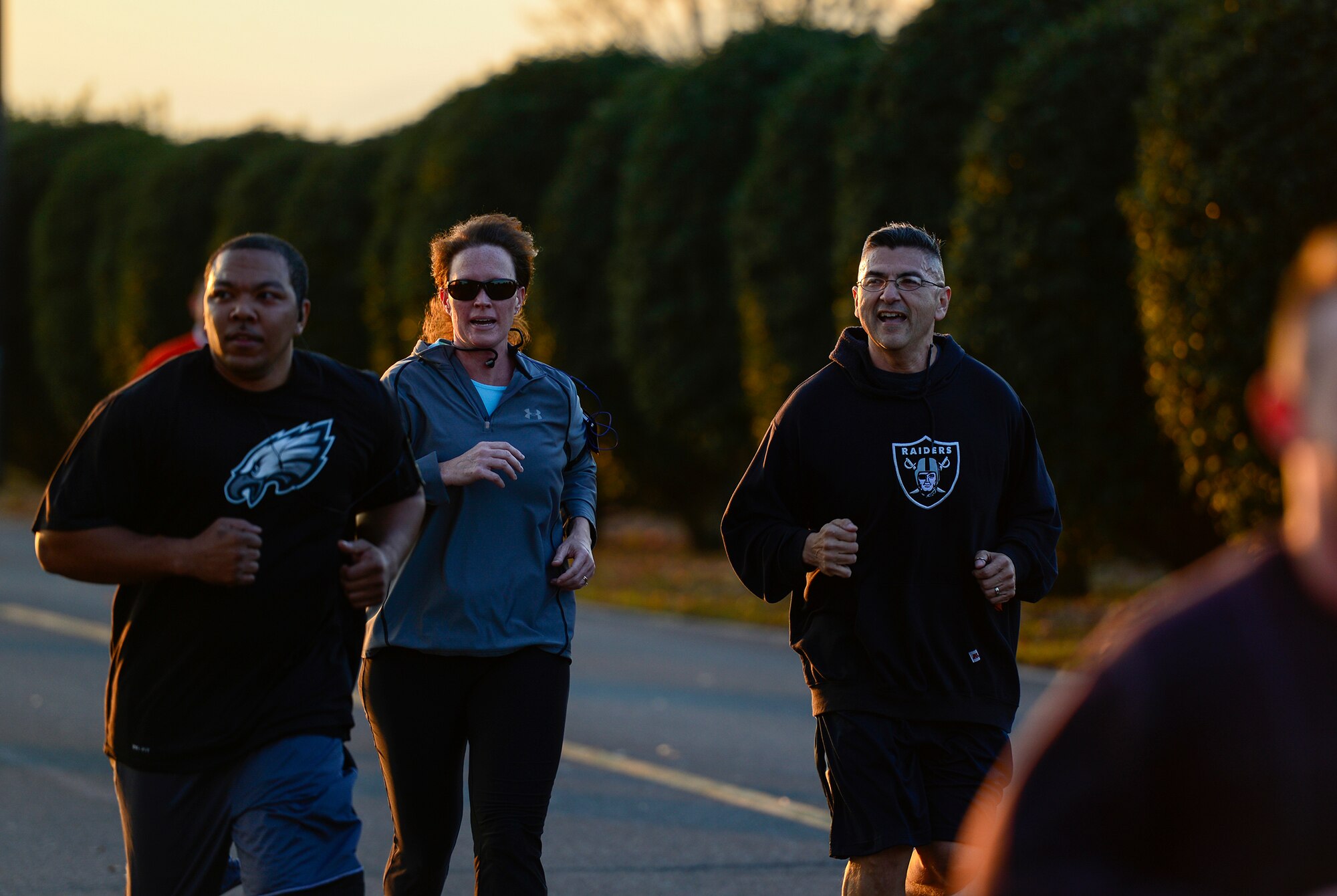 Chief Master Sgt. Manuel Roblesreynoso, 374th Airlift Wing command chief, runs alongside Cris August, wife of Col. Mark August, 374 AW commander, during an Ugly Sweater 5k run at Yokota Air Base, Japan, Dec. 5, 2013. Leadership throughout Yokota participated in the run to share holiday spirits with the community. (U.S. Air Force photo by Senior Airman Cody H. Ramirez)