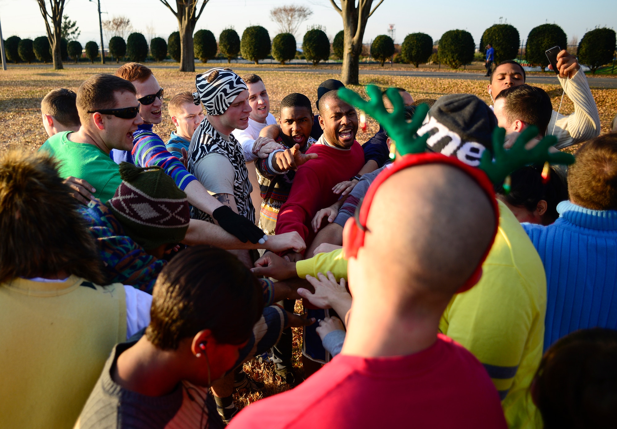 Members of the current Yokota Airman Leadership School huddle before an Ugly Sweater 5k run at Yokota Air Base, Japan, Dec. 5, 2013. More than 80 community members participated in the 374th Force Support Squadron event. (U.S. Air Force photo by Senior Airman Cody H. Ramirez)