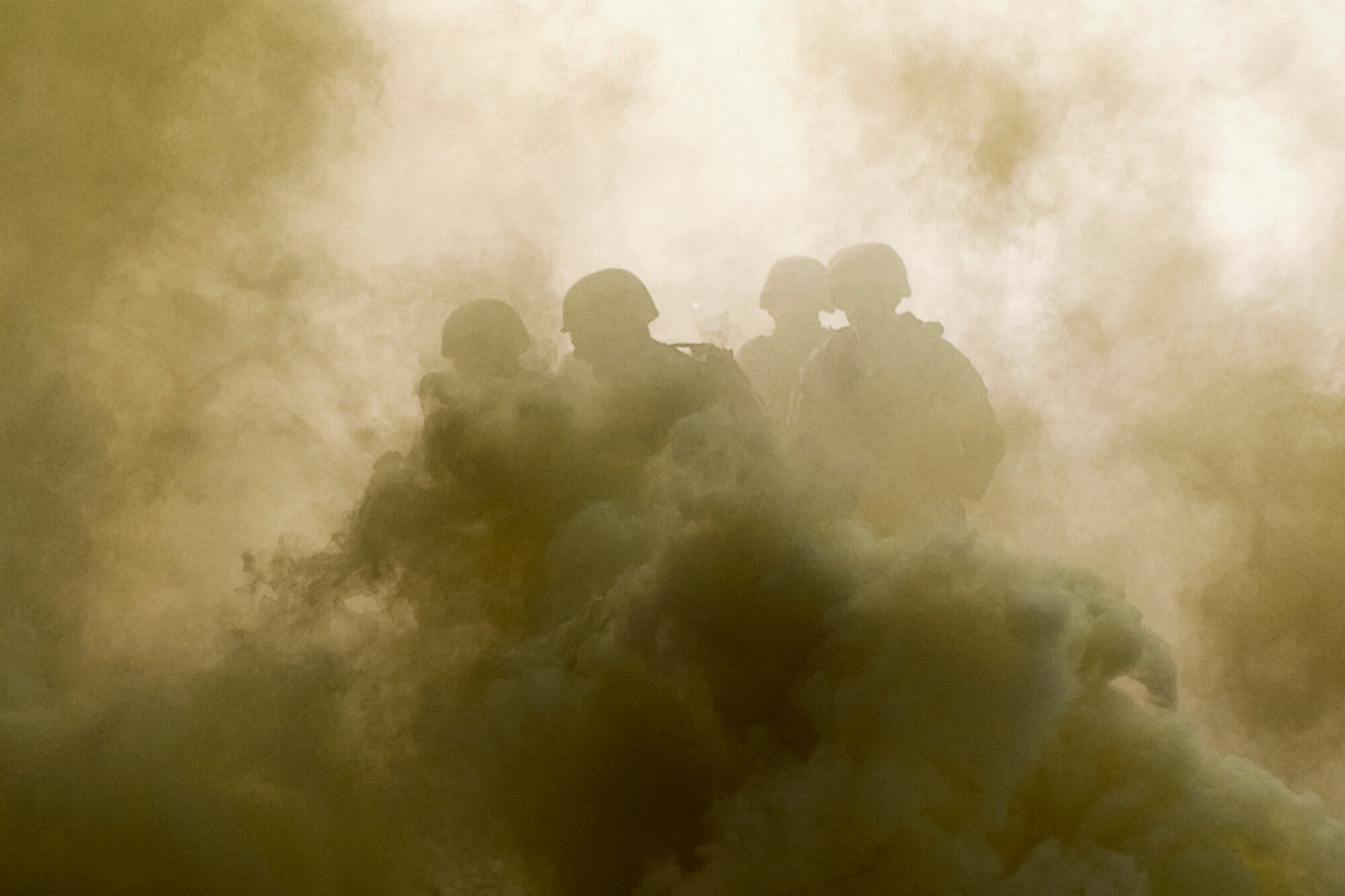 U.S. Marines from Detachment One, Communication Company, Combat Logistics Regiment 45, 4th Marine Logistics Group, make their way through smoke as they secure a building at a simulated overseas location during a joint, mass-casualty exercise held at Grissom Air Reserve Base, Ind., Aug 4, 2013. The Marines teamed up with Air Force security forces, explosives ordnance disposal and medics from the 434th Air Refueling Wing during the exercise. (U.S. Air Force photo/Tech. Sgt. Mark R. W. Orders-Woempner)