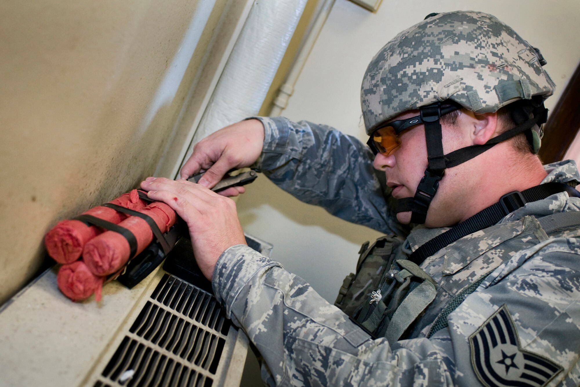 U.S. Air Force Tech. Sgt. Justin Krautkremer, 434th Civil Engineer Squadron explosive ordnance disposal technician, disables a simulated improvised explosive device during a joint, mass-casualty exercise held at Grissom Air Reserve Base, Ind., Aug. 4, 2013. Air Force EOD technicians embedded with Air Force security forces Airmen and U.S. Marines during the exercise, which was held in a simulated foreign country. (U.S. Air Force photo/Tech. Sgt. Mark R. W. Orders-Woempner)