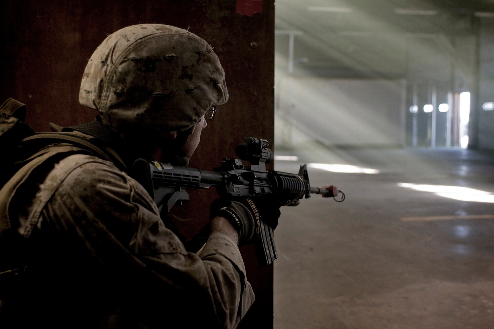 A U.S. Marine guards an entryway into an old fire station at Grissom Air Reserve Base, Ind., during a joint, mass-casualty exercise held at the base Aug. 4, 2013. The fire station was used to simulate a voter registration office in a foreign country where a joint U.S. force made up of Airmen and Marines were assigned to protect the democratic voting process. (U.S. Air Force photo/Tech. Sgt. Mark R. W. Orders-Woempner)