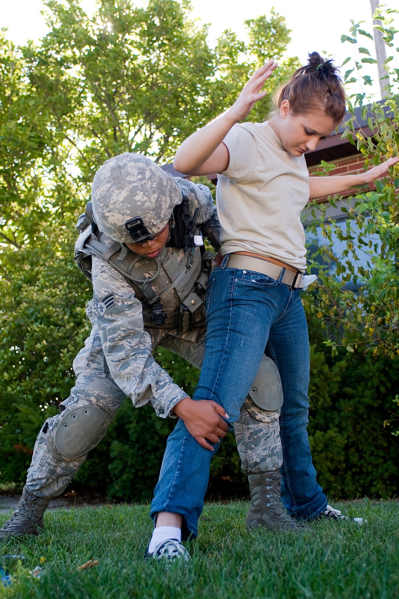 U.S. Air Force Senior Airman Krystal Collier, 434th Security Forces Squadron fire team member, searches Indiana National Guard Pfc. Michaela Bauman, Detachment 1, 38th Military Police Company military policeman, during a joint, mass-casualty exercise held at Grissom Air Reserve Base, Ind., Aug. 4, 2013. Bauman was playing the role of a civilian trying to register to vote in a simulated foreign nation, and Collier was assigned to a security team protecting the civilians during that process. (U.S. Air Force photo/Tech. Sgt. Mark R. W. Orders-Woempner)