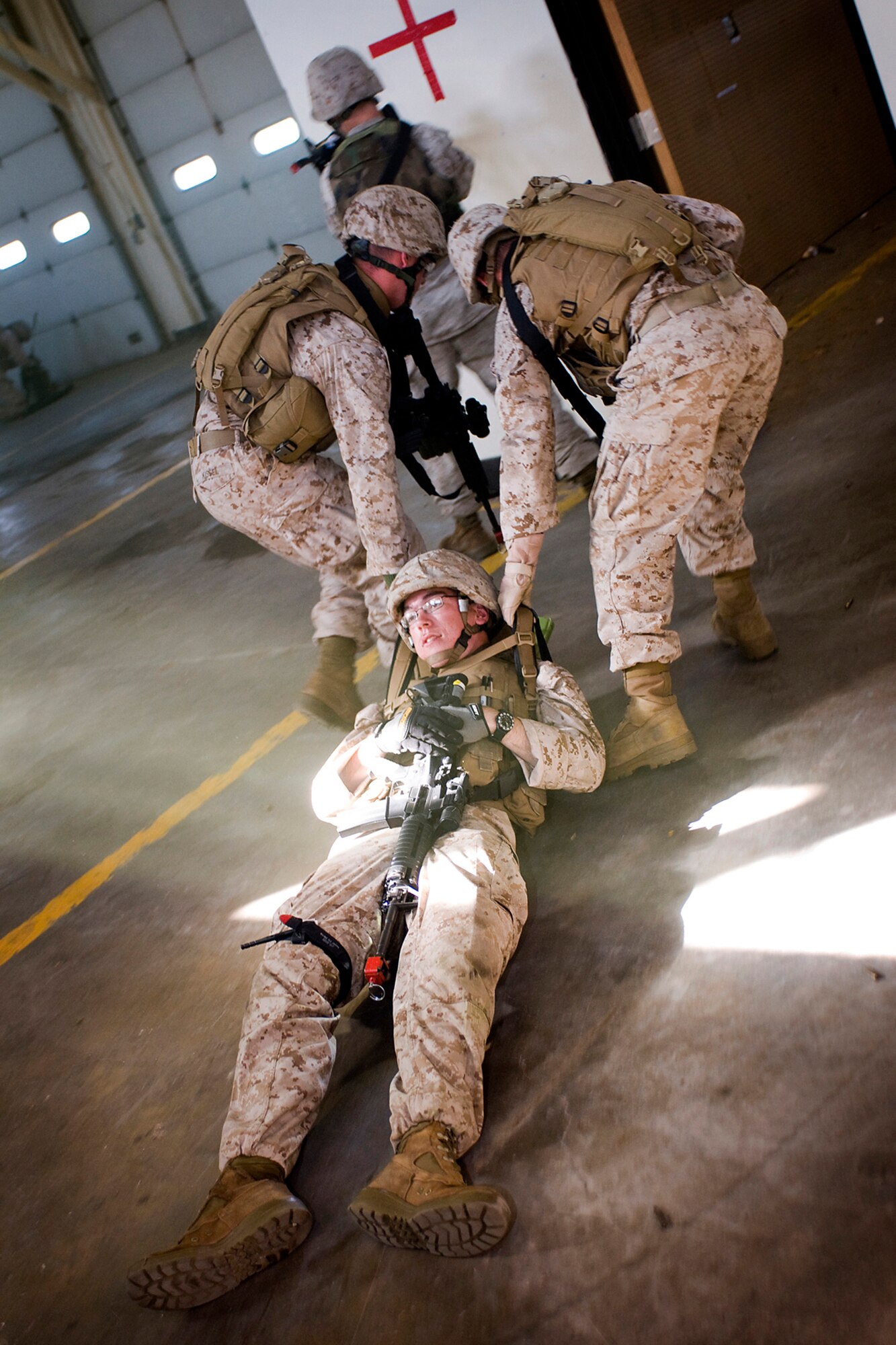 U.S. Marines pull Lance Cpl. Bryan Corder, a fellow Marine from Detachment One, Communication Company, Combat Logistics Regiment 45, 4th Marine Logistics Group, to safety after he received simulated gunshot wounds during a joint, mass-casualty exercise held at Grissom Air Reserve Base, Ind., Aug. 4, 2013. Corder and other Marines joined U.S. Air Force personnel in the exercise that dealt with the protection of a democratic voting process in a foreign nation. (U.S. Air Force photo/Tech. Sgt. Mark R. W. Orders-Woempner) 