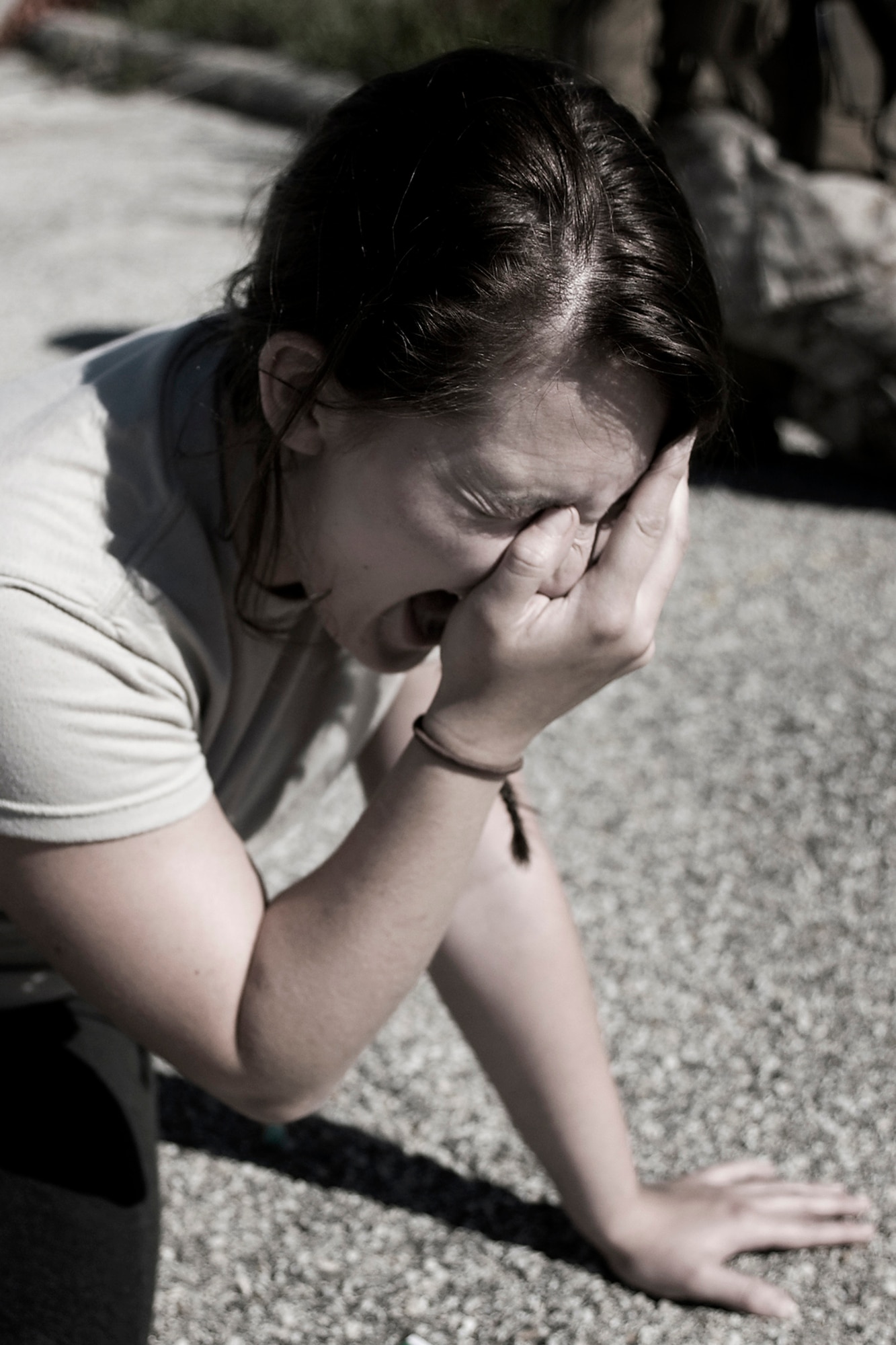 Indiana Army National Guard Pvt. Ashley Rapka, Detachment 1, 38th Military Police Company, cries in anguish as she plays the role of a civilian who just lost her family in an improvised explosive device attack during a joint, mass-casualty exercise held at Grissom Air Reserve Base, Ind., Aug. 4, 2013. Rapka, along with other Soldiers, Marines and Airmen, acted as civilians of an overseas country during the exercise to make the training more realistic. (U.S. Air Force photo/Tech. Sgt. Mark R. W. Orders-Woempner) 