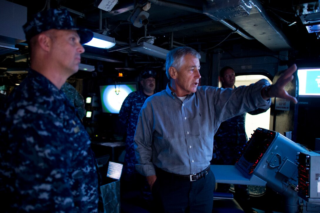 U.S. Defense Secretary Chuck Hagel, right, speaks with U.S. Navy Capt. Dale Maxey, commanding officer of the USS Ponce, during a tour of the ship in Manama, Bahrain, Dec. 6, 2013.